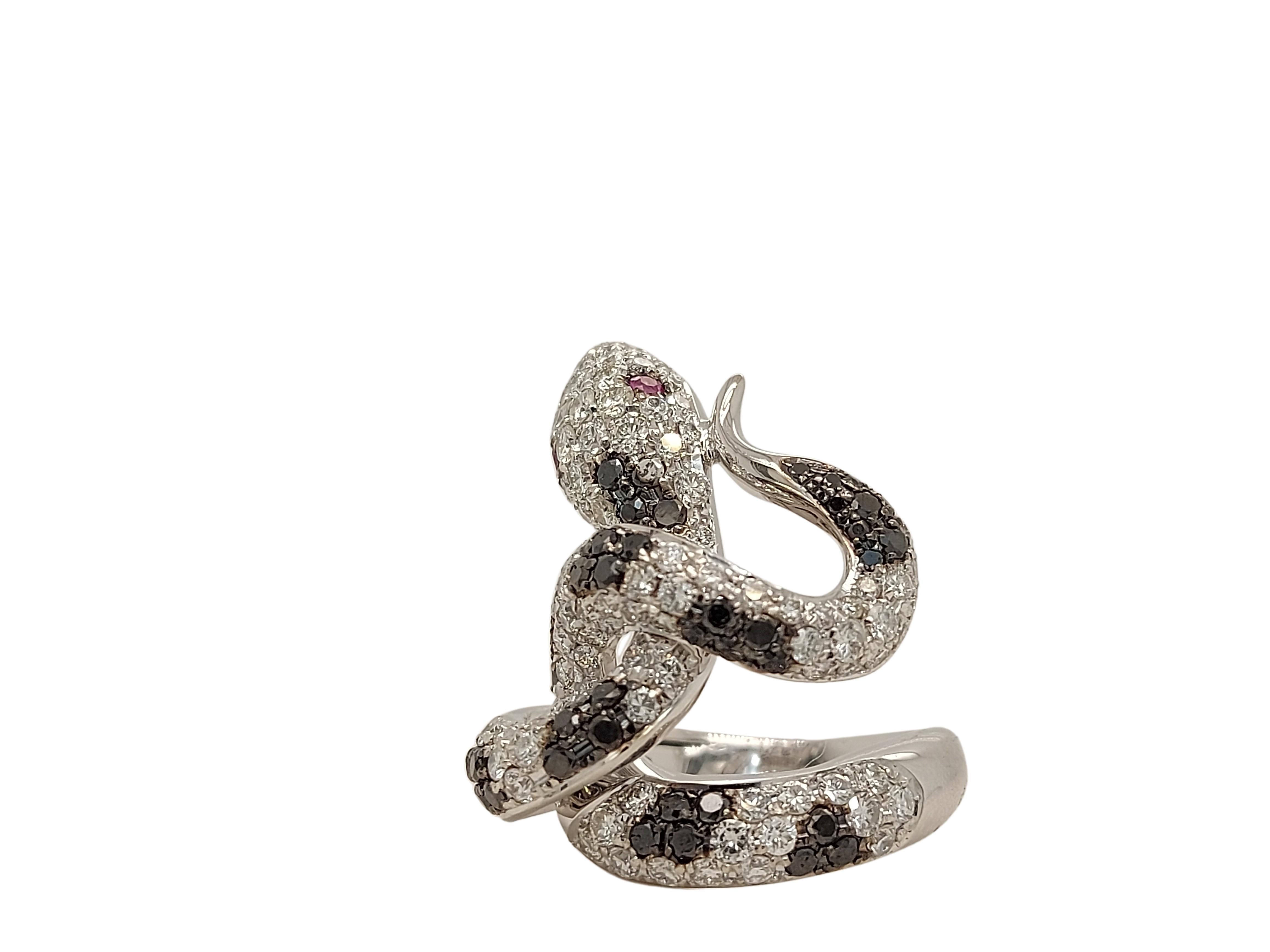 Amazing and Unique 18kt White Gold Snake Ring With 1.28ct Black and 2.83ct White Diamonds With 2 Ruby Eyes

Diamonds: 130 White brilliant cut diamonds, together ca. 2.83ct, 55 Black diamonds together ca. 1.28ct

Ruby: 2 Rubies for the eyes of the