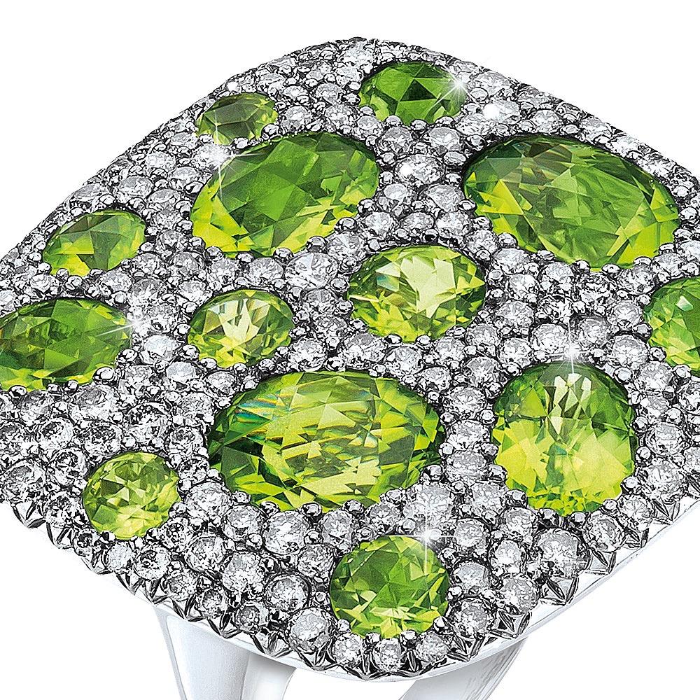 18 karat white gold square cushion shaped ring. This ring is pave set with round silver grey diamonds. Oval peridot stones are set within the diamonds for a beautiful contrast. The ring measures 1.25