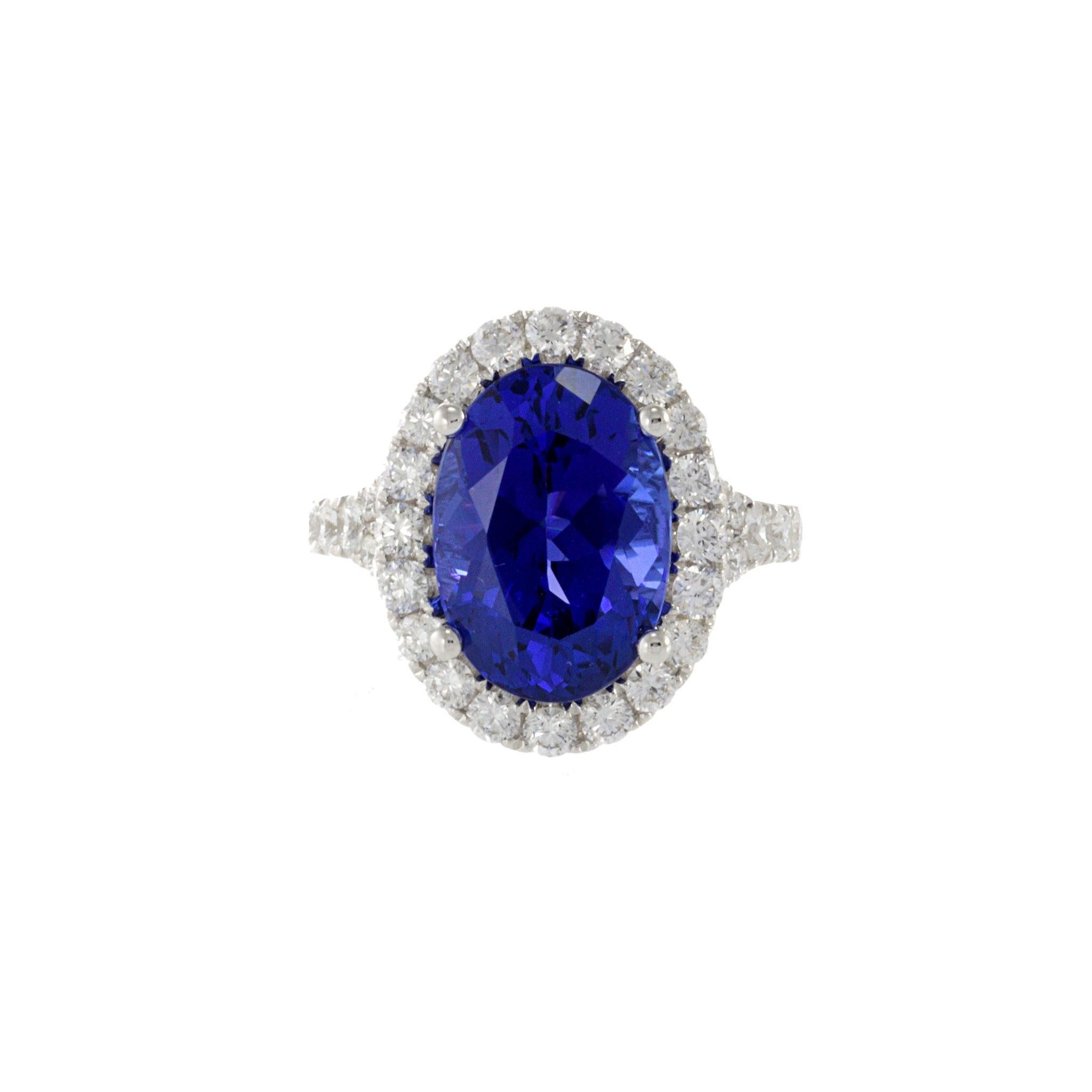 A stunning and unique 18KT white gold ring with a certified 7.71CT natural oval cut tanzanite and 1.40CT-TW G-H VS1-VS2 round cut diamonds, as verified by the IGI Report. Elevate your style and add a touch of luxury to any outfit with this exquisite