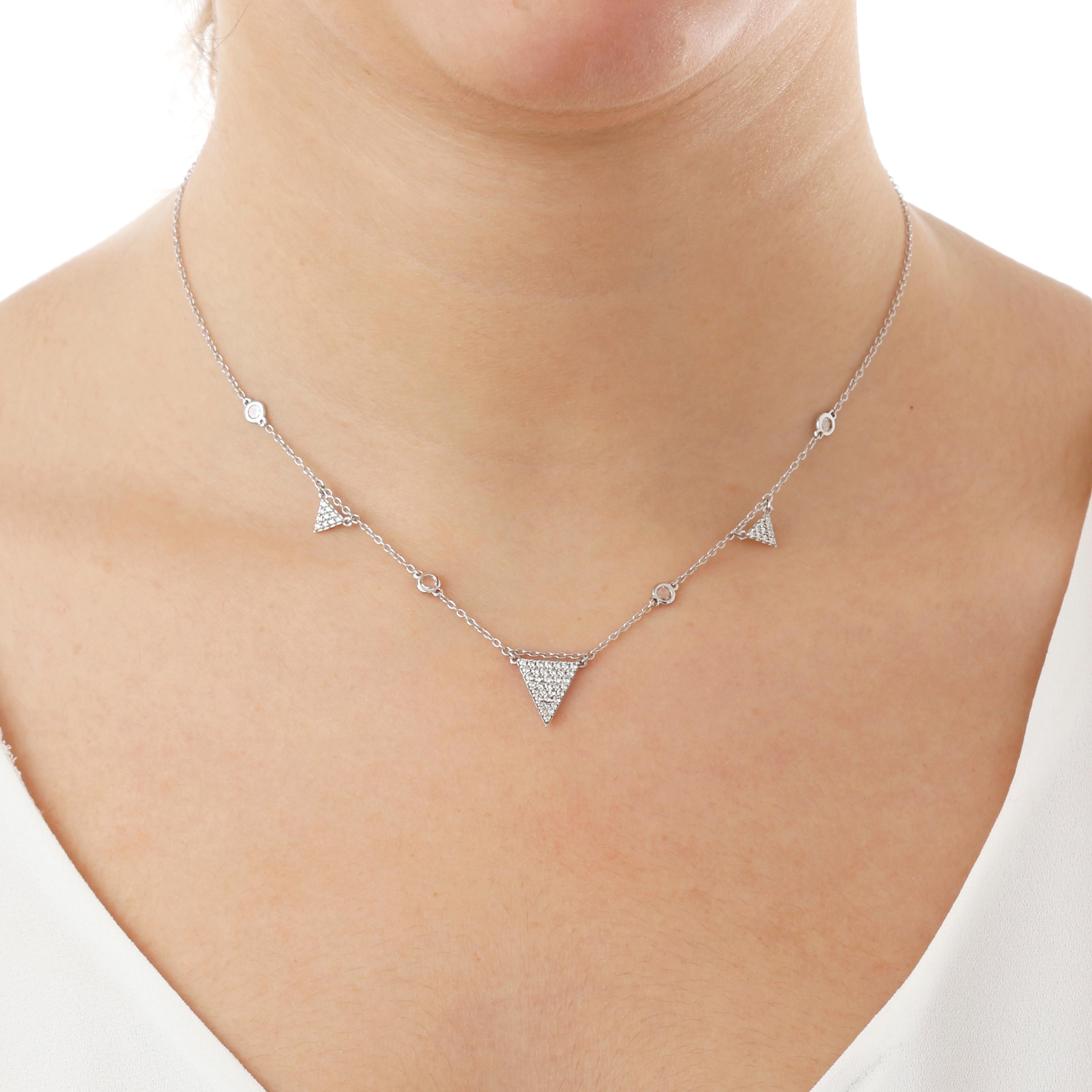 This 18KT white gold is embellished by 3 diamonds pavè triangles. 
These are separated by chain and 4 small diamonds. 
The 3 triangle motif gives it a rocker touch. 
The necklace is composed of 3,8 gr of 18Kt gold and 0,60 cts of white natural