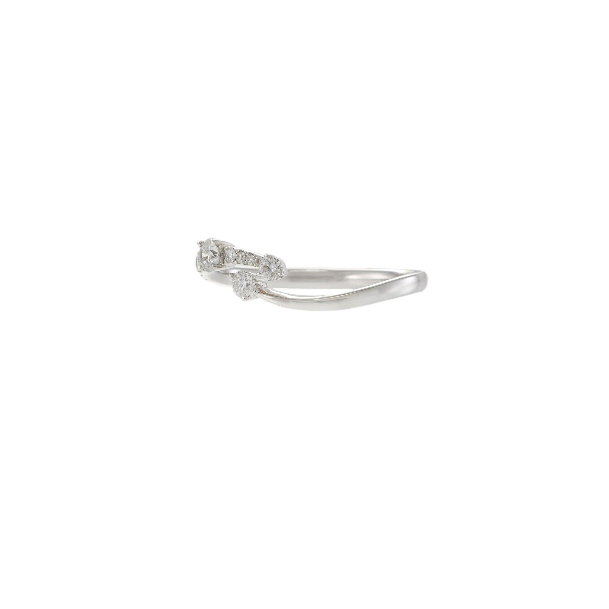 A modern take with a playful bend. This 18KT white gold ring flows in a soft twist, giving movement to a classic diamond band. Along the curve, 13 round diamonds totaling 0.30 carats add brightness without going over the top. Each G-color,