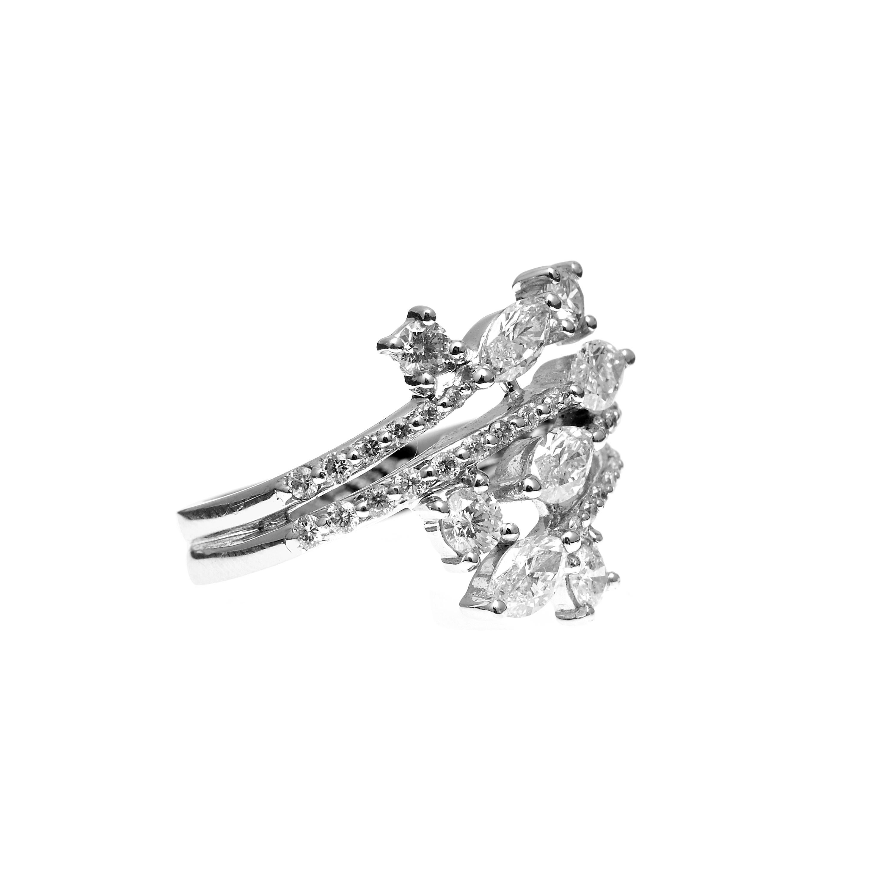 This interesting and modern ring has unique flair with edgy mixed diamond shapes. Featuring a total of 1.53ct of dazzling diamonds. The Marquise shapes contrast so nicely against the small round accent stones. Hand finished with 18kt white gold to