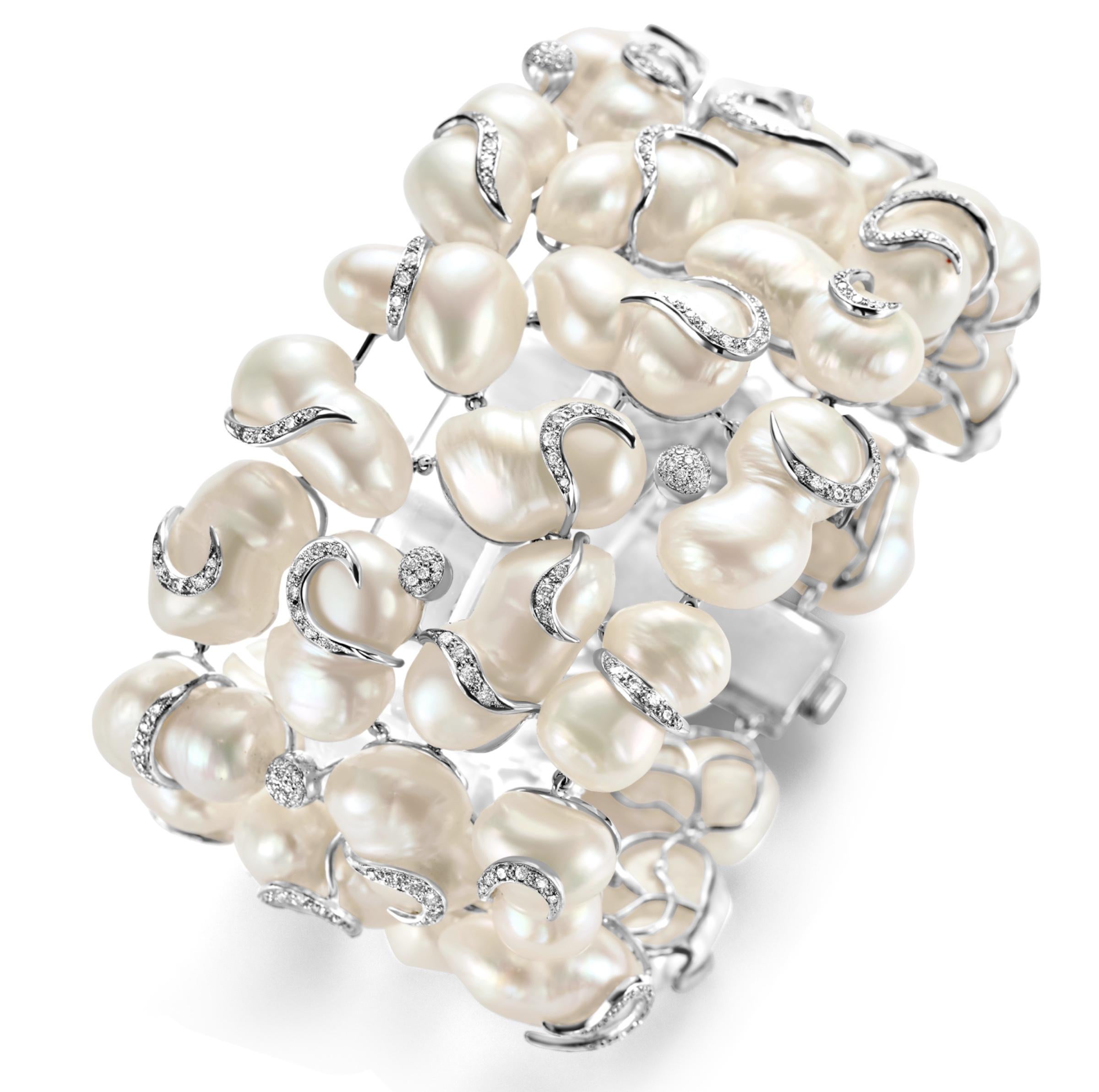 This Yvel bracelet is made with ca.5 ct brilliant cut diamonds and fresh water pearls. The calming effect that the pearls give and the brilliance of the diamonds makes this piece so unique. Every row of diamonds is directed to a different side, that