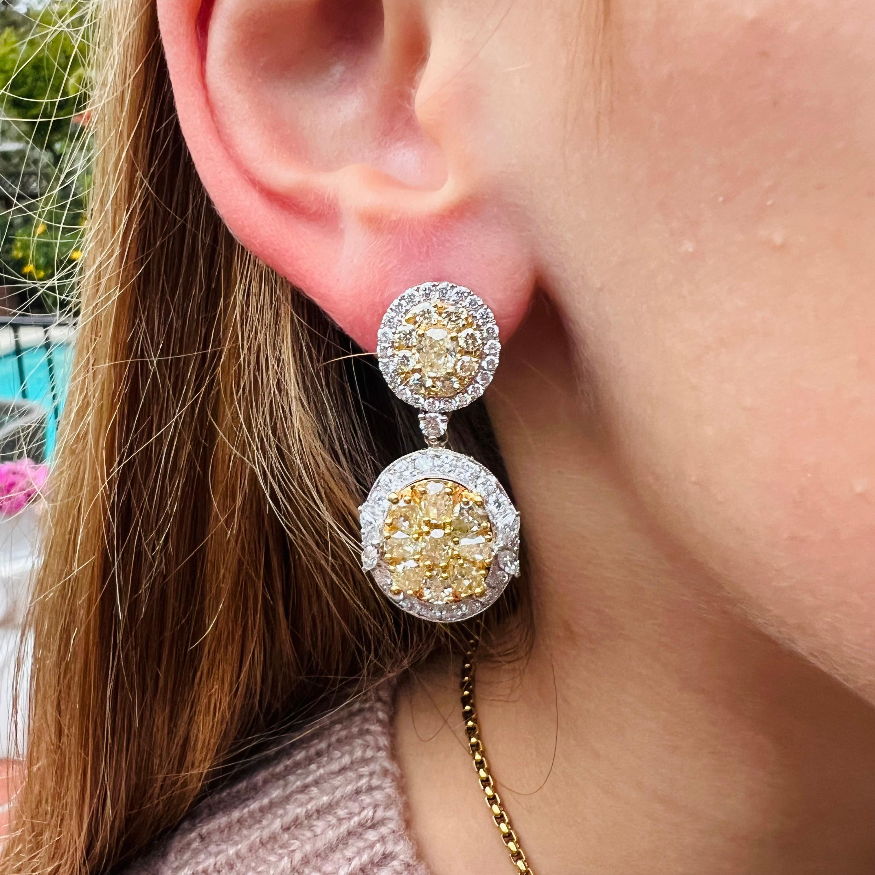A phenomenal addition to any collection! These 18 karat stunners feature gorgeous oval and pear shaped natural yellow diamonds surrounded by halos of fine white diamonds. The fancy yellow diamonds weigh a combined total of approximately 5.0 carats