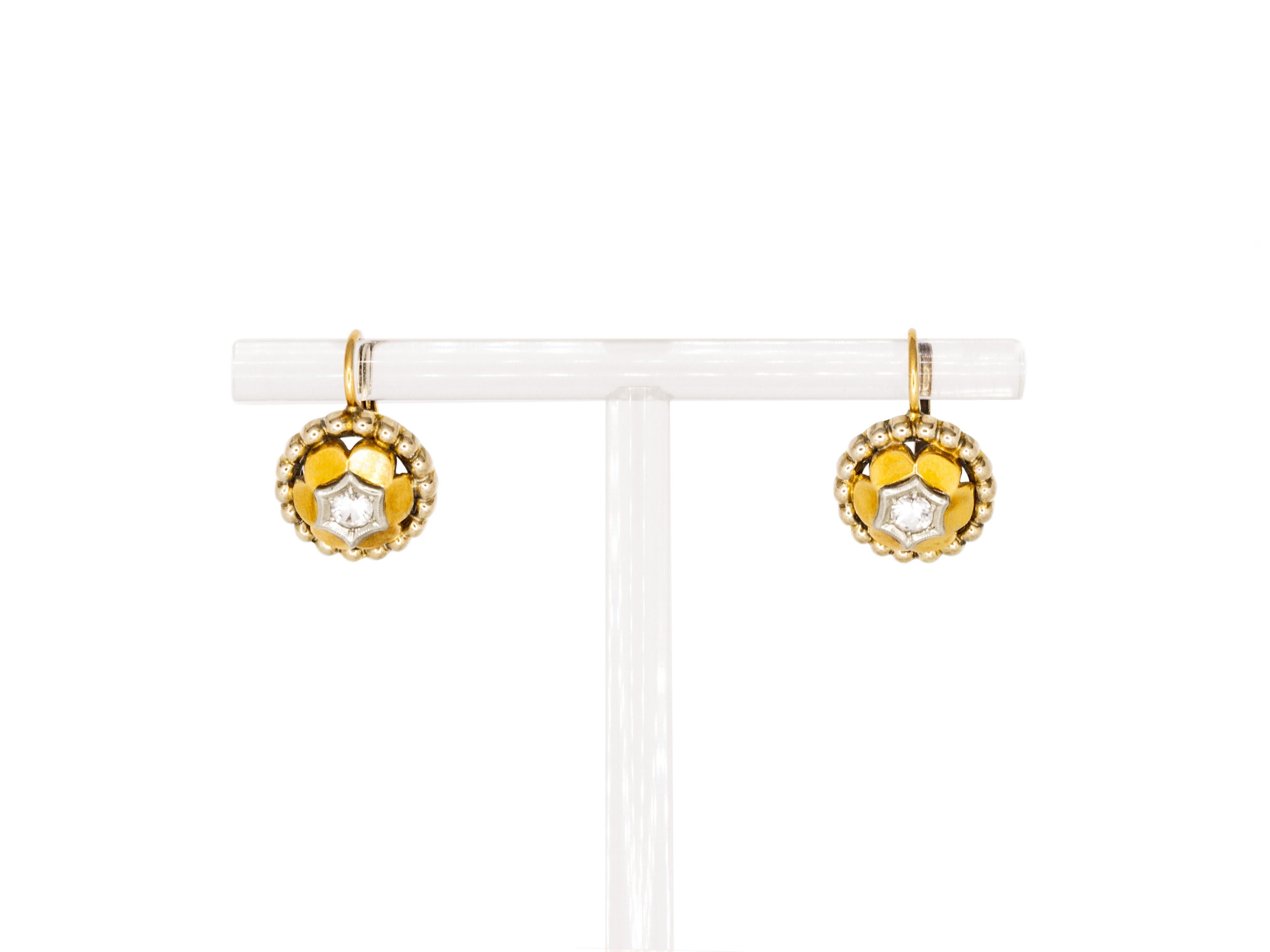 A fascinating pair of earrings giving centre stage to two faceted white sapphires.
Surrounding each earring is a little ball frame in white gold.
These earrings are very light and they can be worn easily for any occasion and all the day.

Lever back