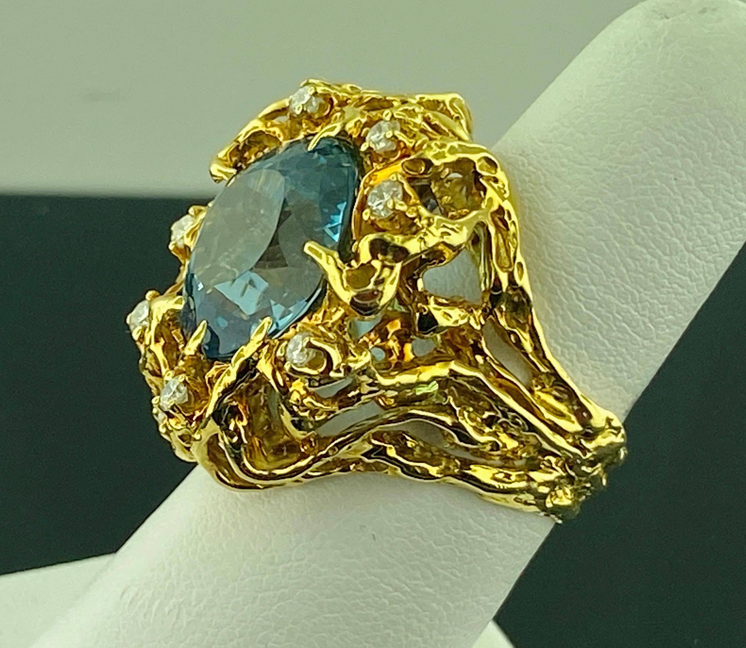 Set in 18 karat yellow gold, weighing 21 grams, is a 10 carat Round Cut Aquamarine highlighted with 8 Round Brilliant Cut diamonds weighing 0.35 carats, Color Grade of: G-H, Clarity Grade of: SI-1.  Ring size is 8.