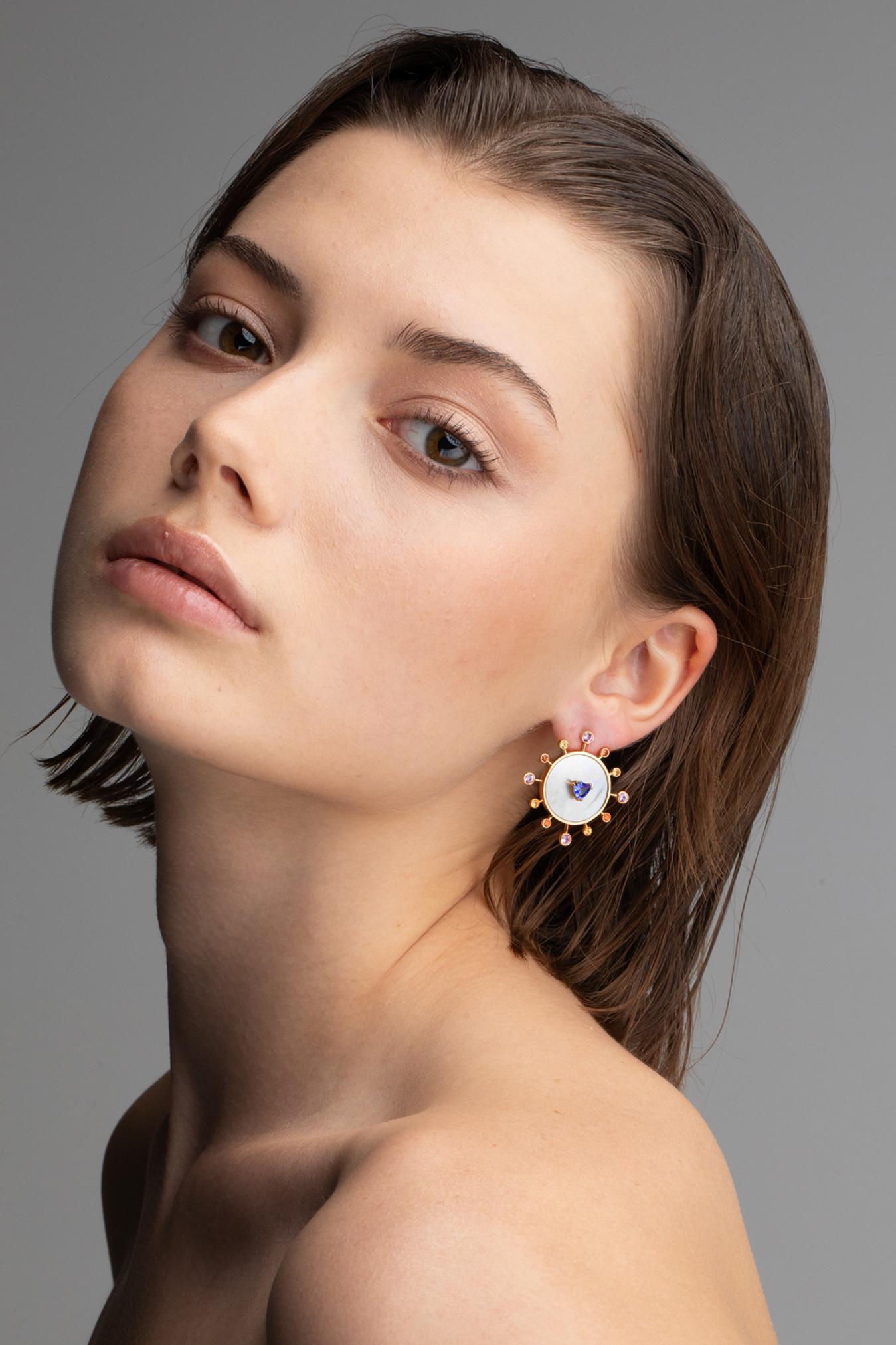 Sunray Collection- Truly Inspired by watch's geometry and modernism- it expresses joy and energy through colors and light. 
Sunray Earrings are made by 18kt yellow gold ( 10,8 gr), natural trillions cut Tanzanite ( mm 5x5) , 12 multicolor sapphires