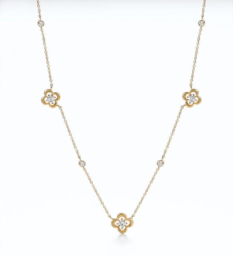 18KT yelow gold station diamond flower necklace. 3 LILY CUT ® flower shape diamond H color VS SI clarity  0.53 cts . additional 0.22 ct round diamond accent .   17 inch with a link to shorten to 16 inch . 