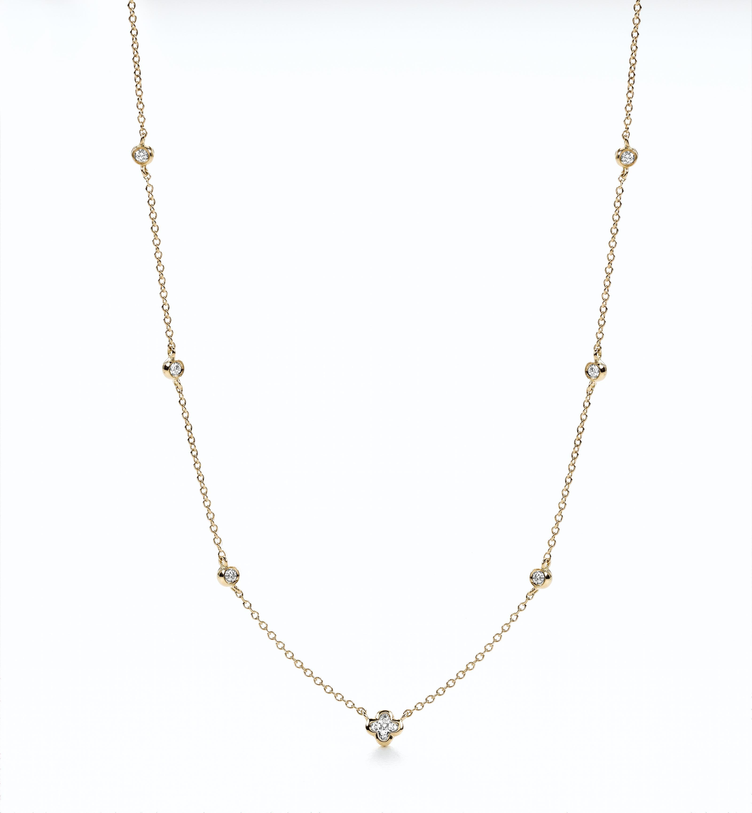 18KTyellow gold station diamond round and flower necklace. 1  LILY CUT ® flower shape diamond H color VS SI clarity  0.18 cts . additional 0..17 ct round diamond accent .   17 inch with a link to shorten to 16 inch . 