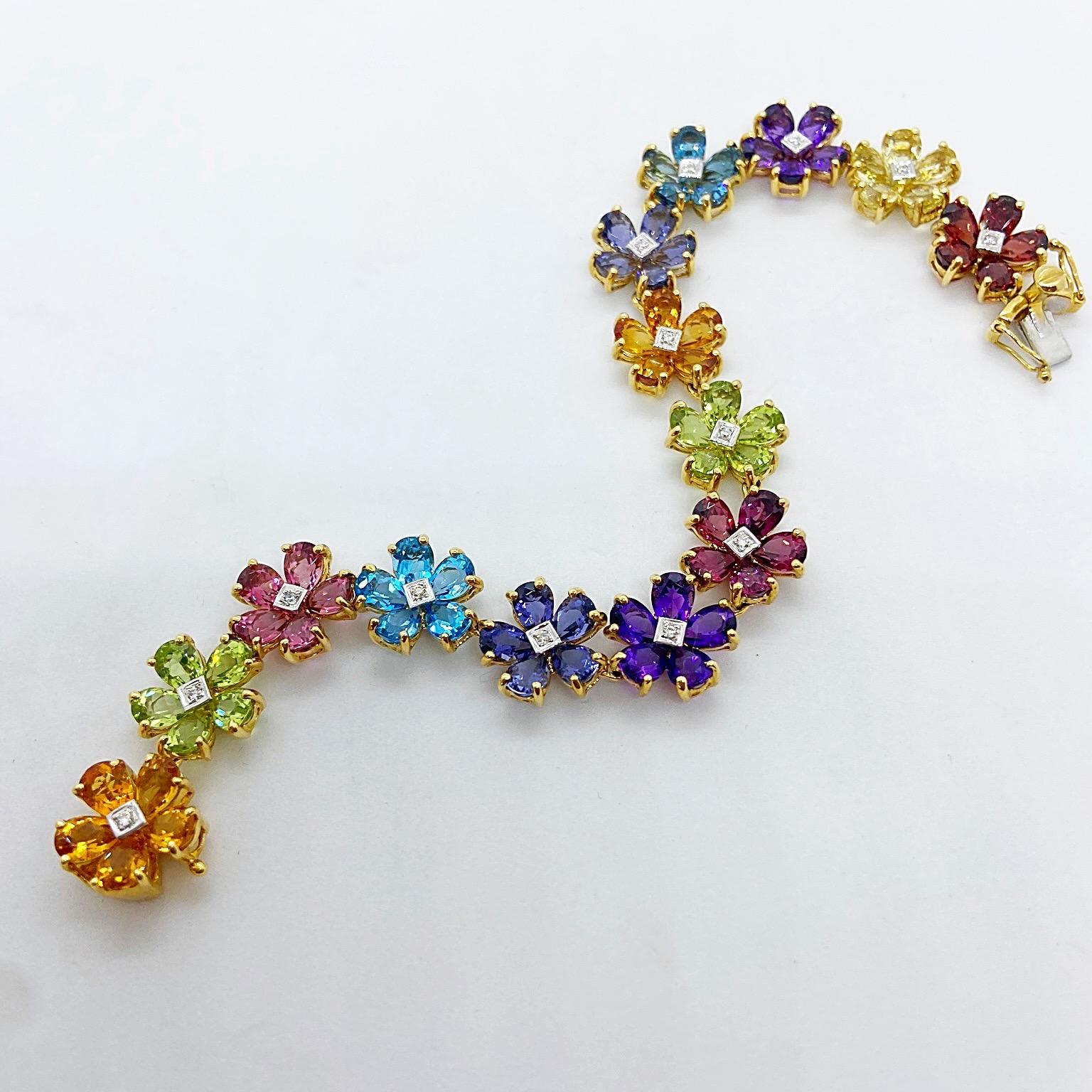A Bouquet of Semi Precious Stone Flowers with Diamonds

This bracelet is designed with 14 flowers set in 18 karat yellow gold. Each flower has 5 pear shaped petals and a round brilliant Diamond center. The Semi Precious stones are Garnet, Lemon