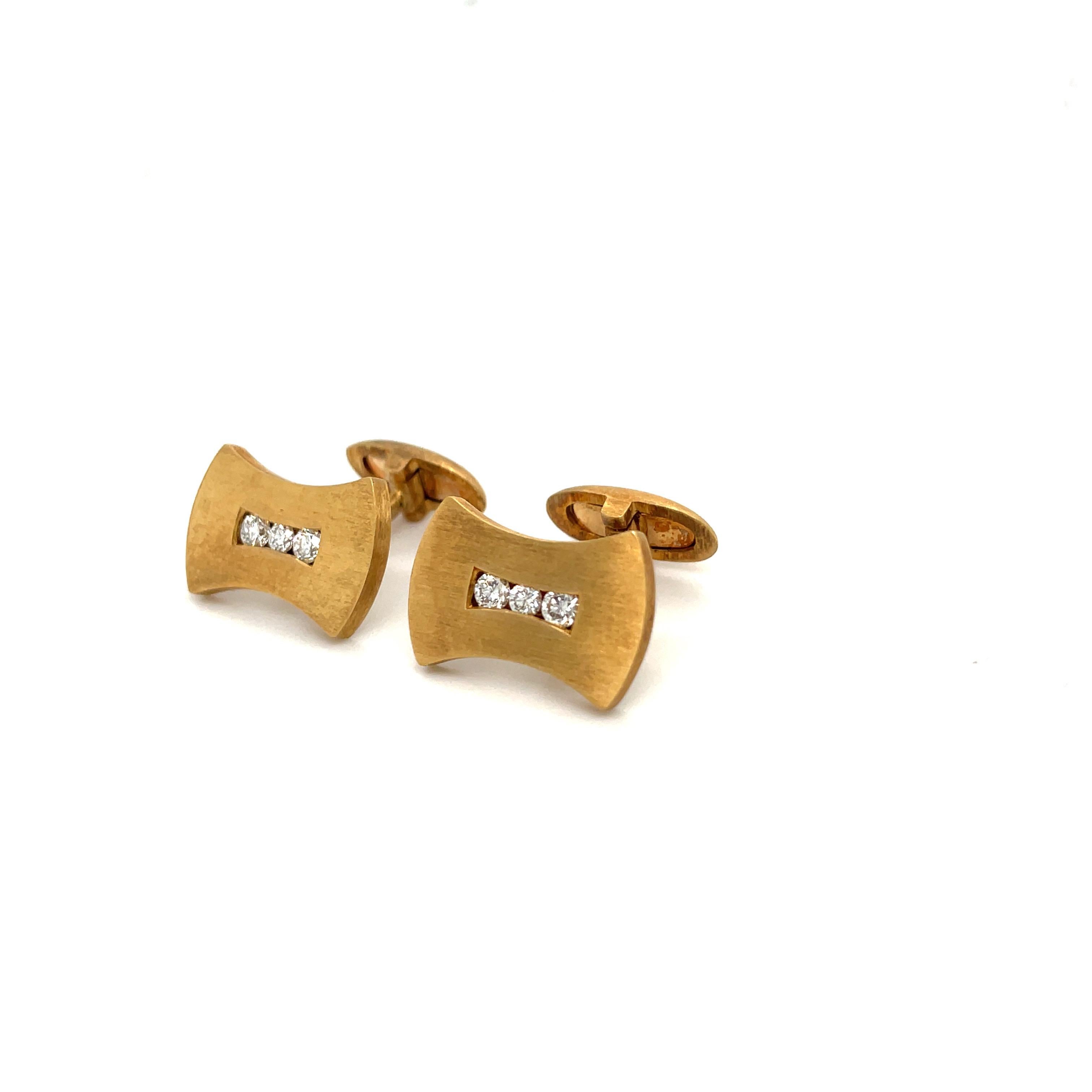 Elegant and festive 18 karat yellow gold cuff links. The bow tie shaped cuff links are designed in a matte finish and are set with round brilliant diamonds, total weight 0.55 carats. The bar back cuff links measure 3/4