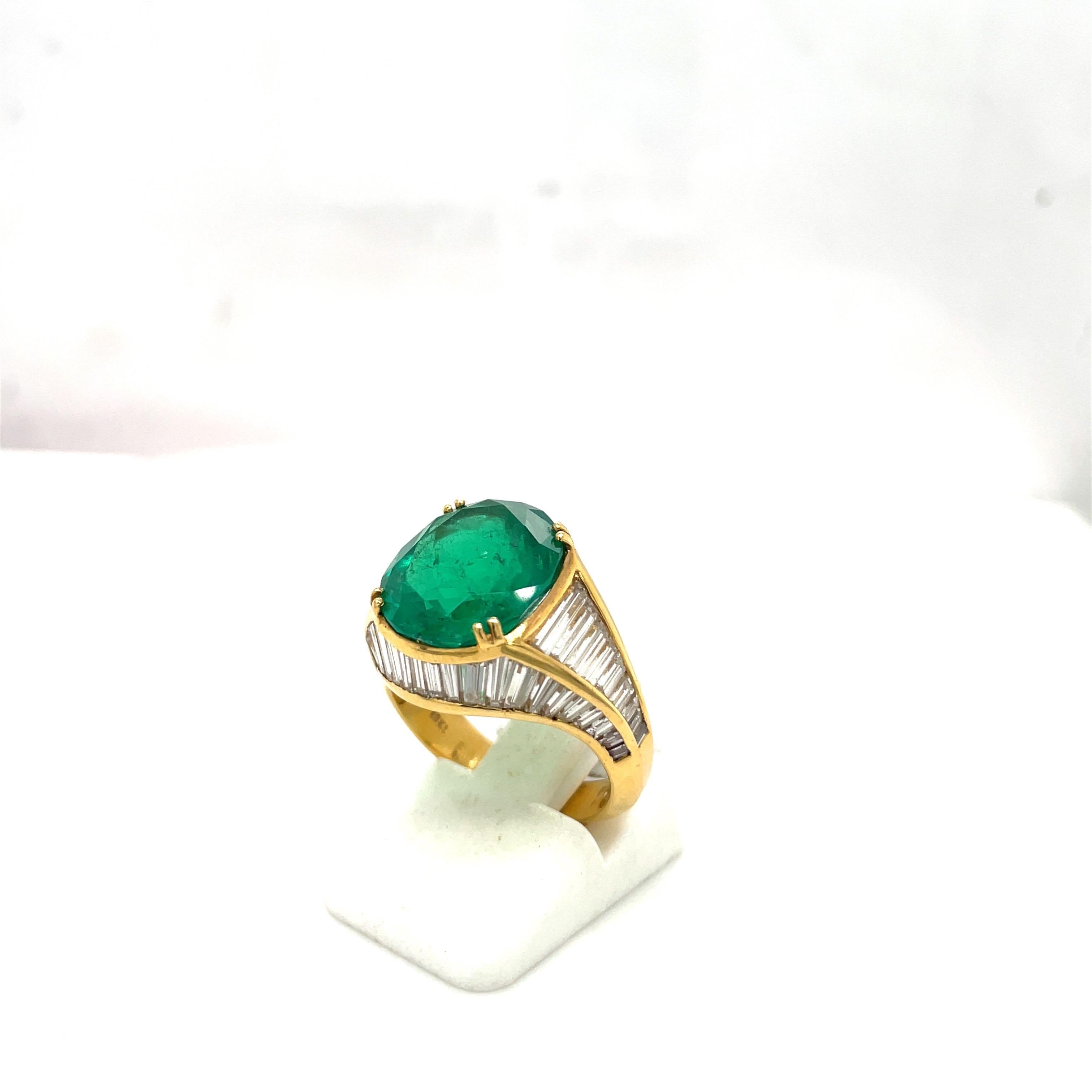 This magnificent 18 karat yellow gold ring features a gorgeous oval emerald weighing 6.00 carats.The unique throne like setting is set with 3.23 carats of baguette cut diamonds . The beauty of this setting is the way the baguettes are set on 4 sides