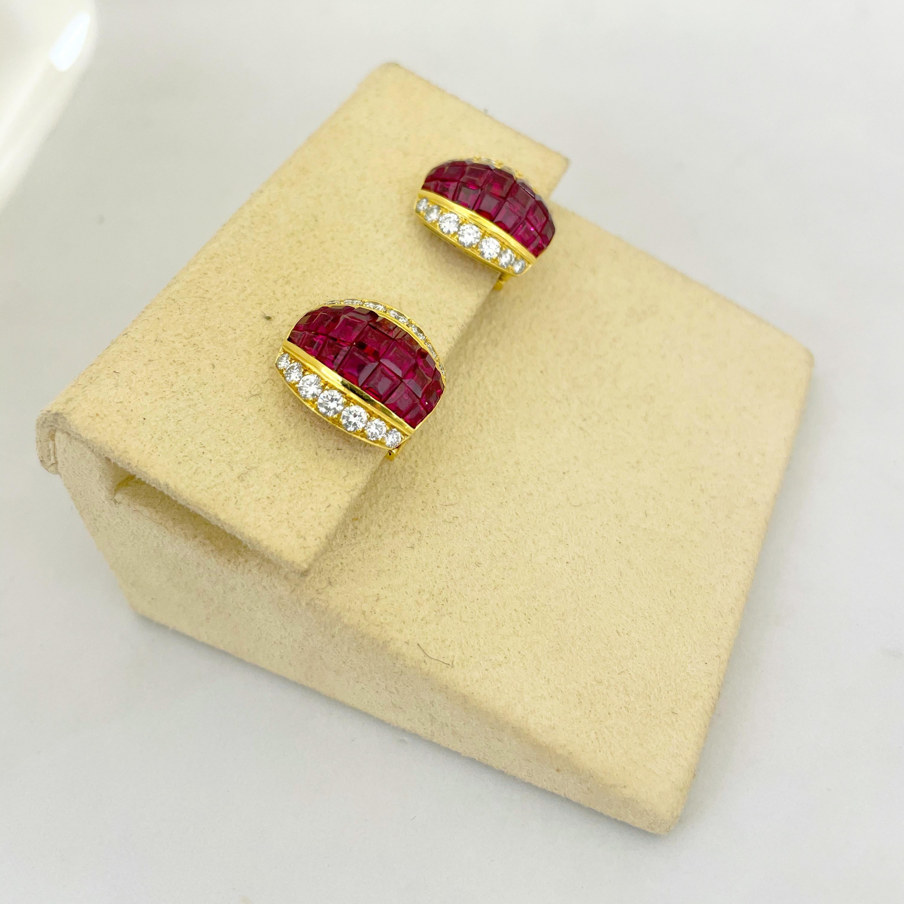 These 18 karat yellow gold earrings have been magnificently set with 3 rows of invisibly set rubies. Round white brilliant diamonds border the rubies on each side . These earrings have collapsible posts making them suitable for pierced and non