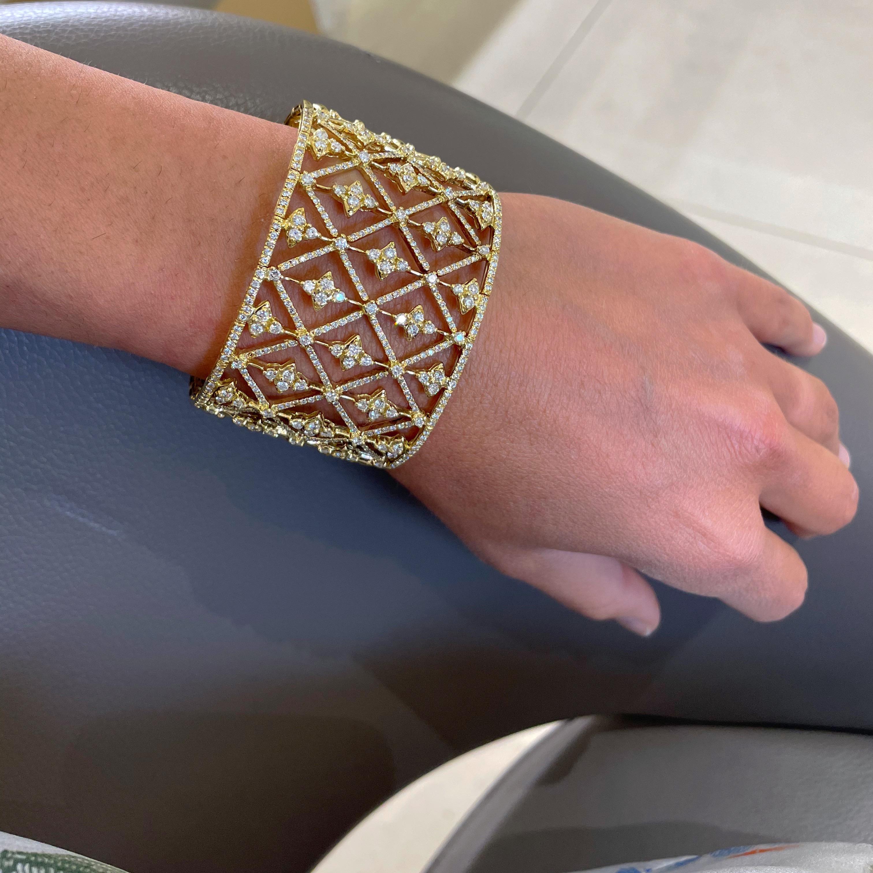 Elegant and extremely wearable is the best way to describe this 18 karat yellow gold and diamond cuff bracelet. The 1.5