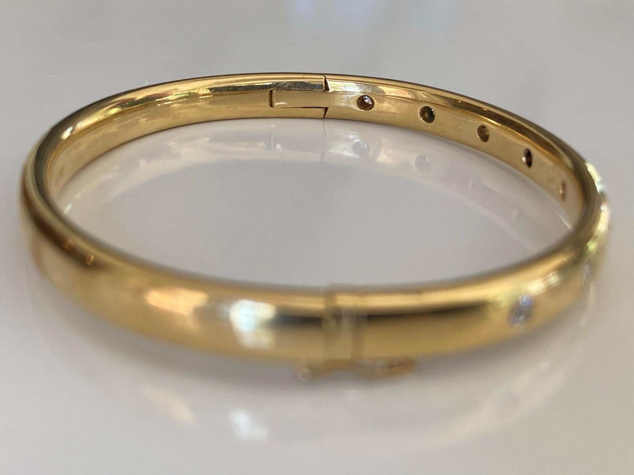Crafted in the 1960s in 18kt solid yellow gold, this estate bangle features eight round diamonds totaling approximately 0.50 carats, H color, SI1 clarity. The bangle measures 6.5 inches.  
