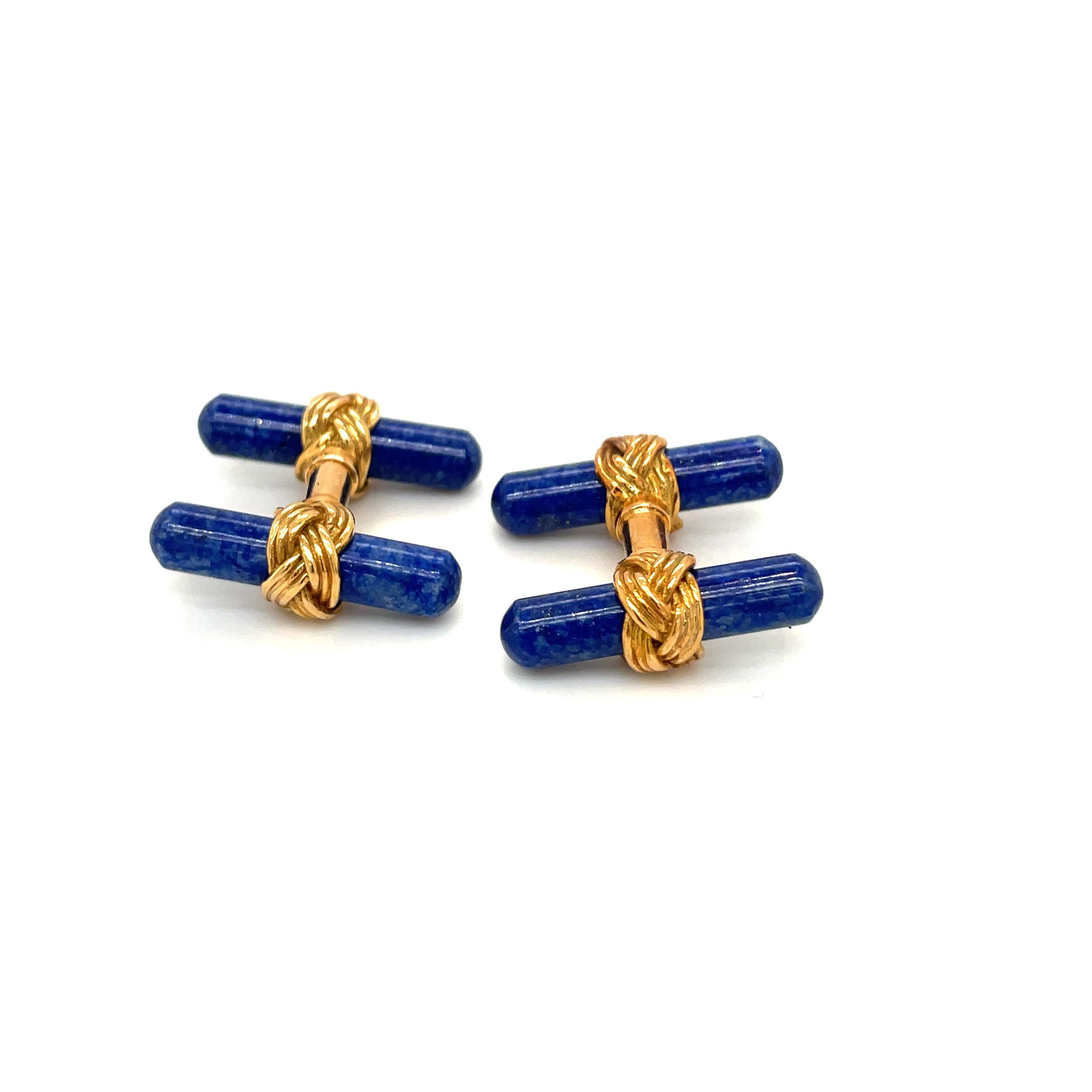 18 karat yellow gold cuff links. The bar style cuff links are double sided . Each end is set with a smooth polished lapis bar held by a yellow gold braid.
The cuff links measure approximately 3/4