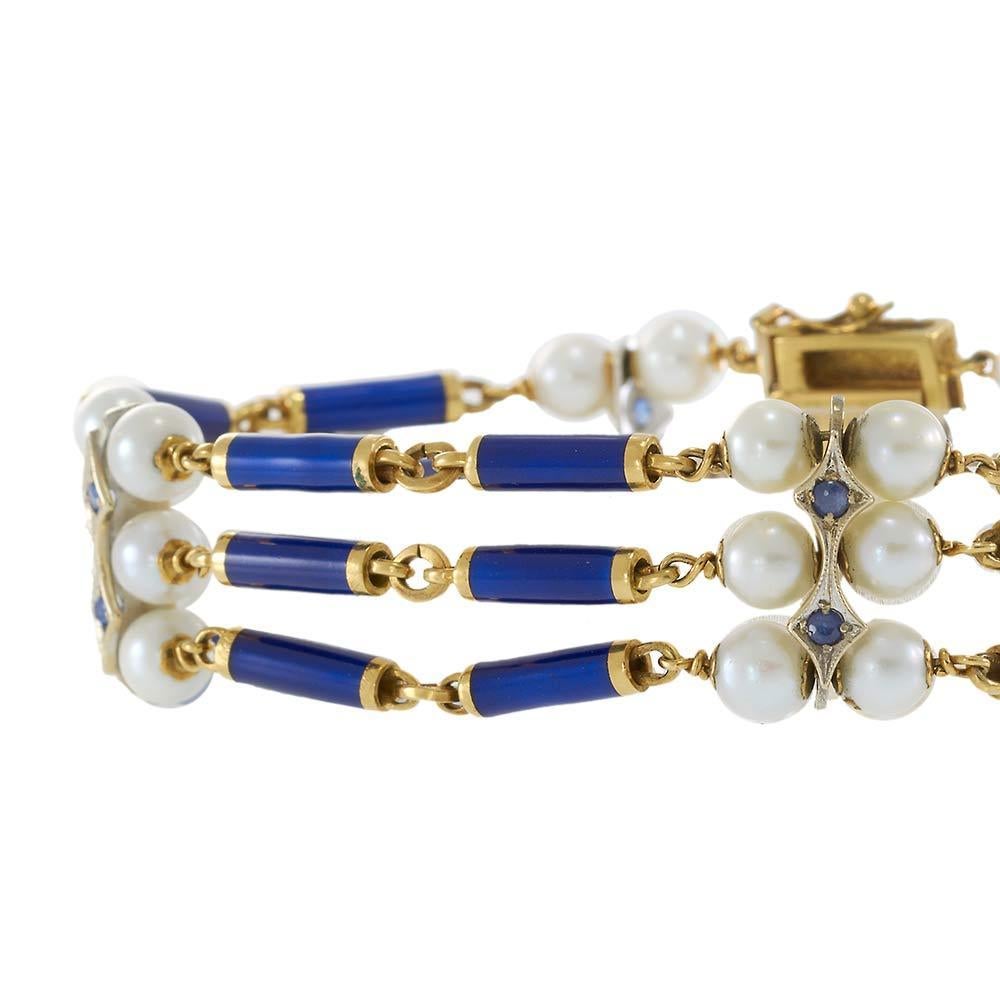 Elegant and timeless, this antique Victorian-era bracelet is crafted in rich 18KT yellow gold, showcasing a stunning three-row design. Deep blue enamel bars are interspersed with luminous 6mm cultured pearls, creating a striking contrast of color