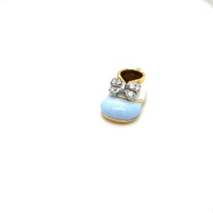 Fiocco in oro giallo 18KT con smalto azzurro/bianco e diamanti da 0,12 carati