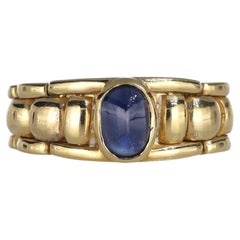 Anello a fascia in oro giallo 18kt con zaffiro centrale