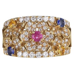 Anillo de oro amarillo de 18 quilates con flores de diamantes y zafiros de colores