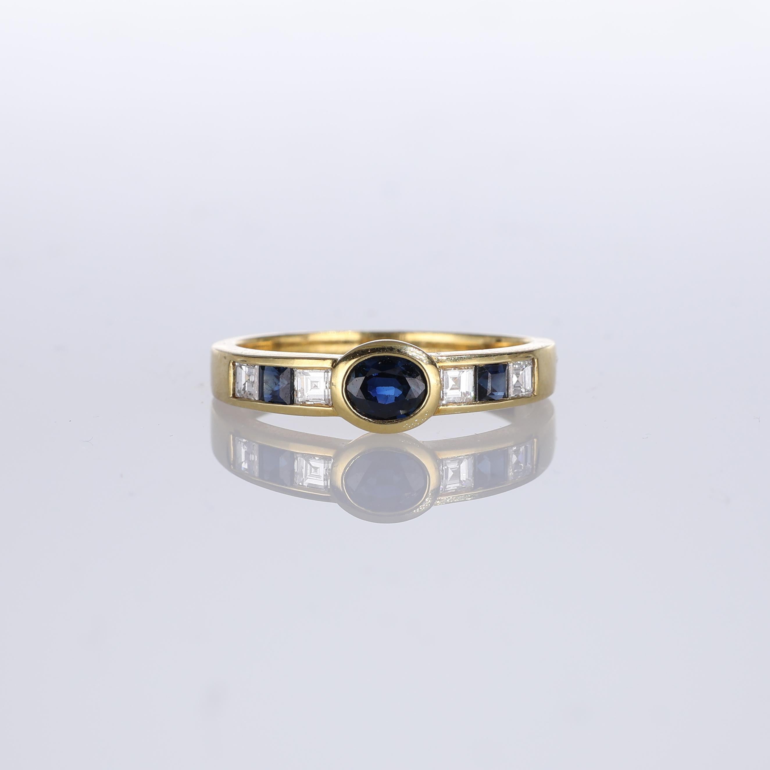 IMPORTANT NOTE:
✔ No additional costs will be added to this order.
✔ Shipping and customs duties are fully covered by us.
--------------------
An 18kt yellow gold band ring featuring a central sapphire and a row of alternating sapphires and