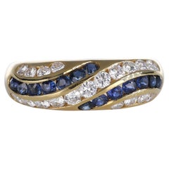 Anello a fascia in oro giallo 18kt con zaffiri e diamanti