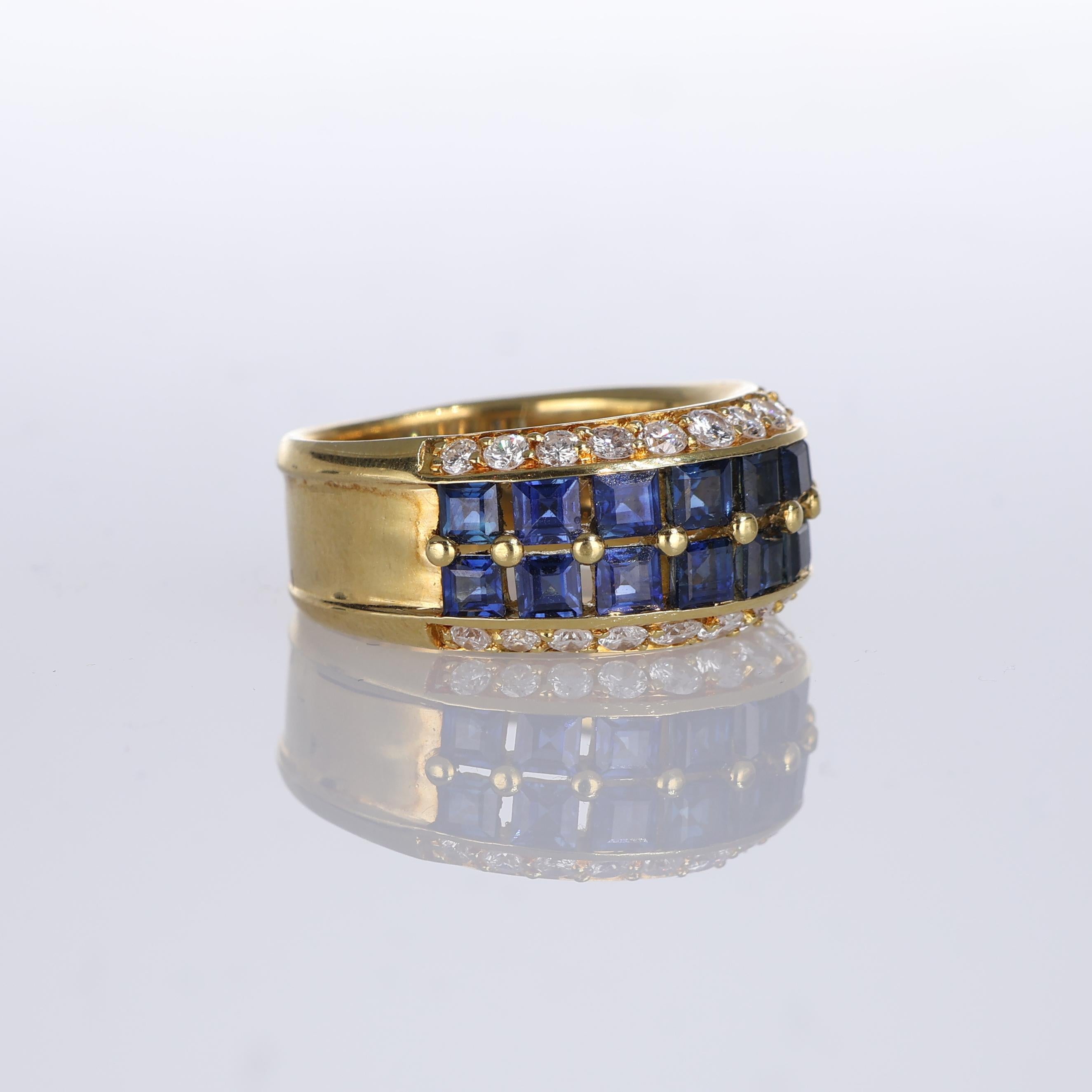 IMPORTANT NOTE:
✔ No additional costs will be added to this order.
✔ Shipping and customs duties are fully covered by us.
--------------------
This 18kt yellow gold band ring features a luxurious row of square-cut sapphires bordered by brilliant-cut