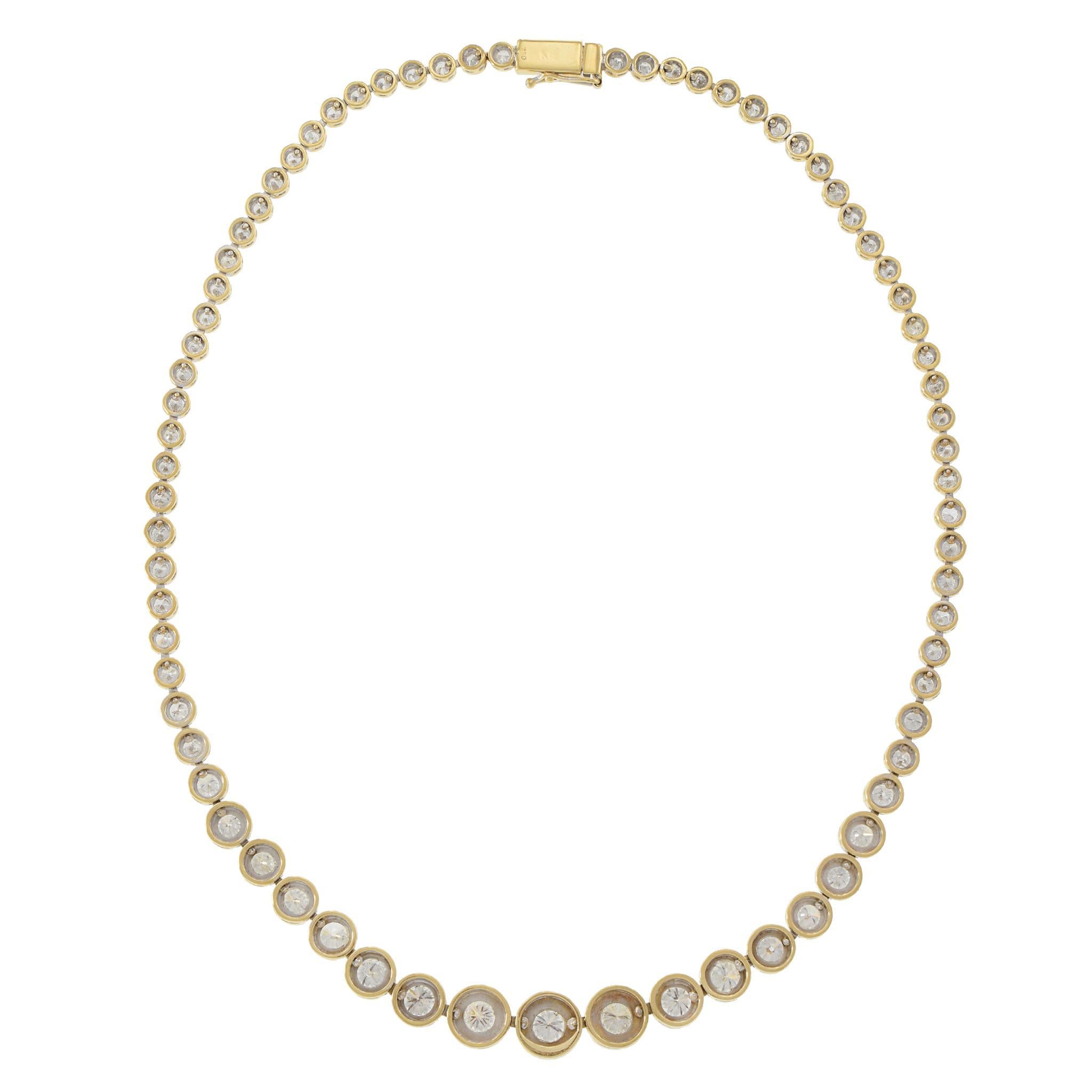 Elegant Diamond Necklace in 18k Yellow Gold. This exquisite necklace features a series of white diamonds, each set in a bezel of 18k yellow gold. The diamonds are graduated in size, creating a harmonious flow around the neck. The primary diamonds