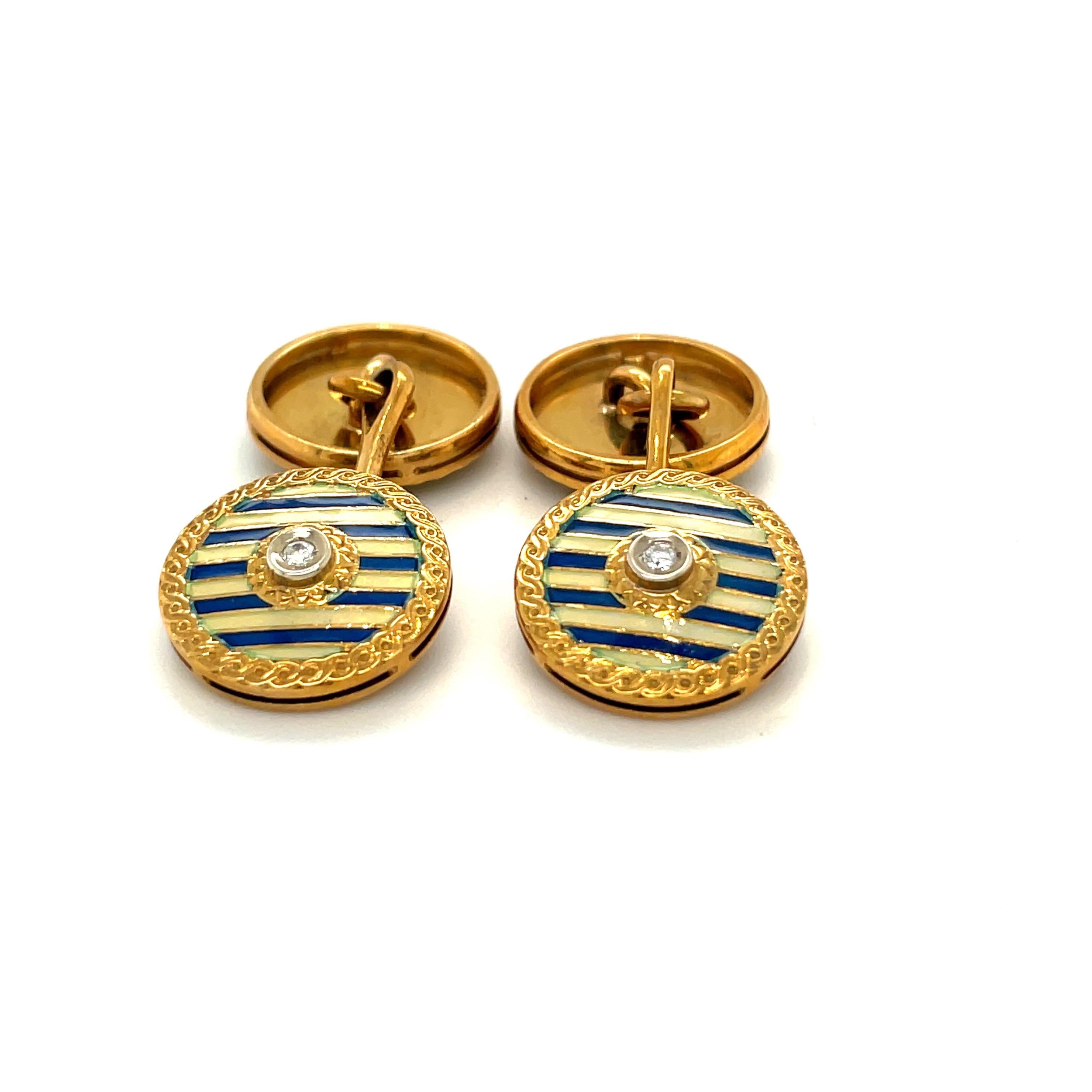 Classic 18 karat yellow gold and enamel cuff links. The 14 mm round cuff links are crafted with a blue and cream striped enamel. A round diamond centers each of the 4 rounds.
Total diamond weight 0.10 carats