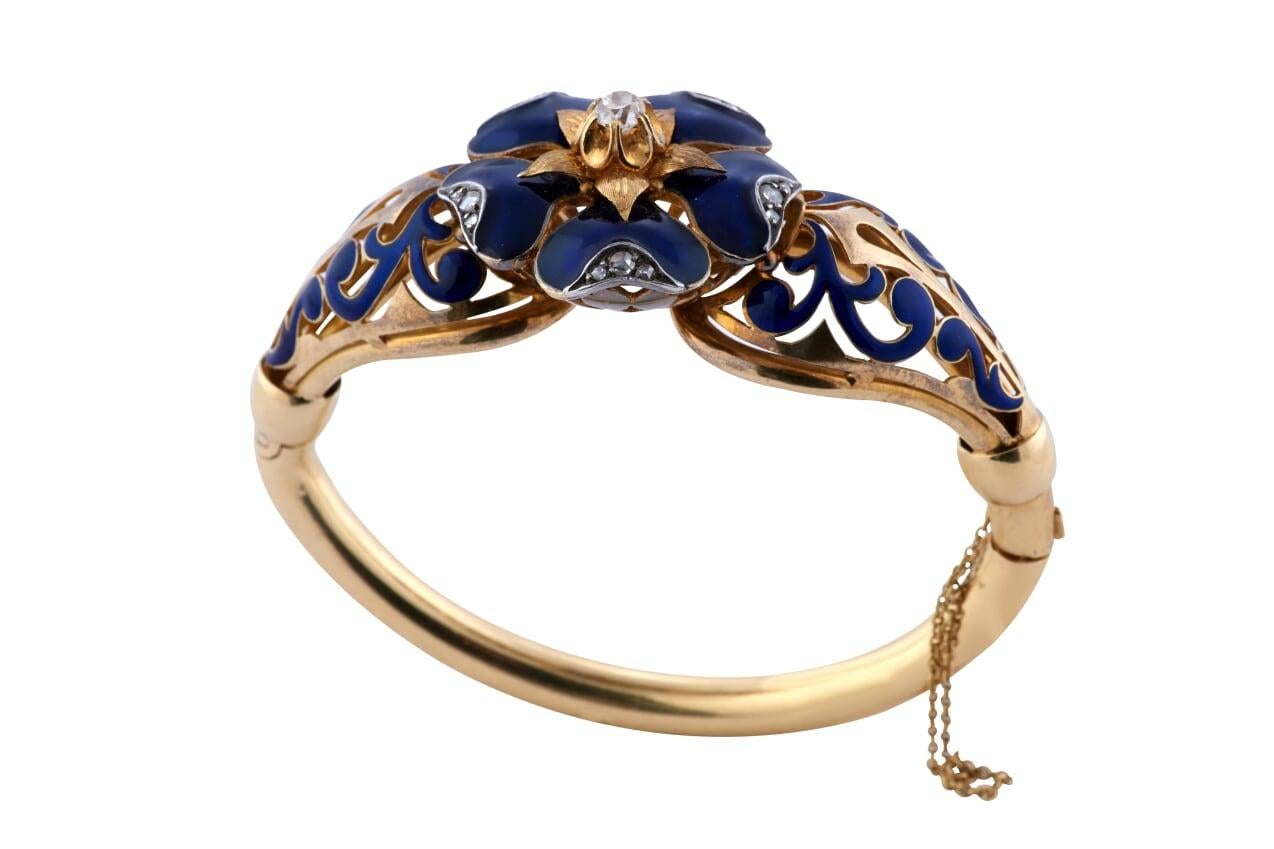 Vintage 18kt yellow gold, blue enameled and old miner cut diamond bangle. The center miner cut diamond is weighing approx 0.50ct SI clarity and H-I color and the side diamonds are weighing approx 0.15ct/tw.