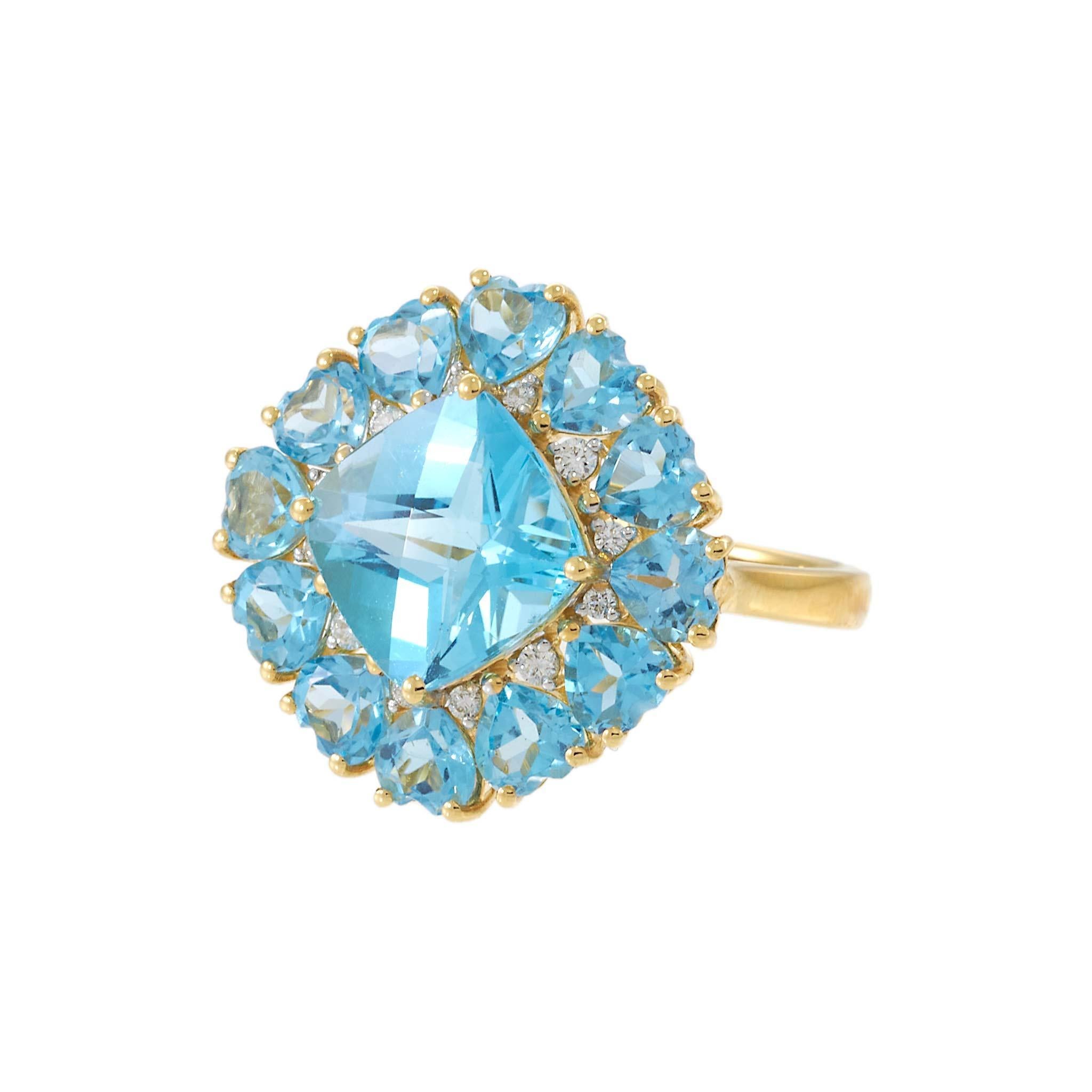 A dazzling expression of color and light, this cocktail ring showcases a vibrant cushion-cut blue topaz framed by a halo of round-cut blue topaz accents and delicate diamond details. The 18KT yellow gold setting adds warmth and contrast, bringing