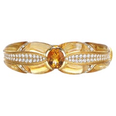 18kt Yellow Gold Bow Motif Rigid Bracelet with Yellow Topaz and Diamonds