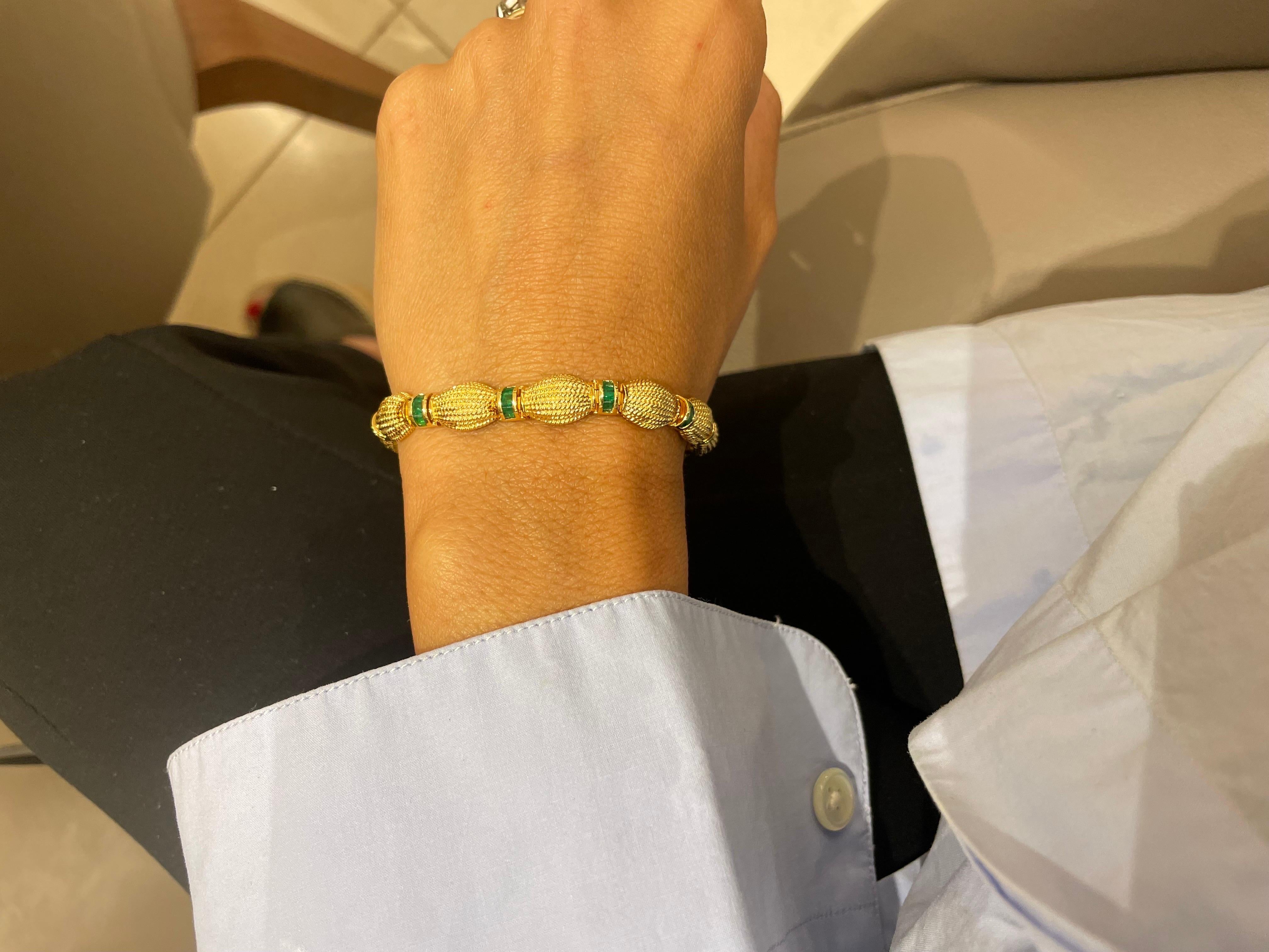 This 18 karat yellow gold bracelet is composed of 12 oval shaped beaded yellow gold links. There are 12 rondelles set with 2.88 carats of square emeralds that alternate with the oval links.
The bracelet measures 7