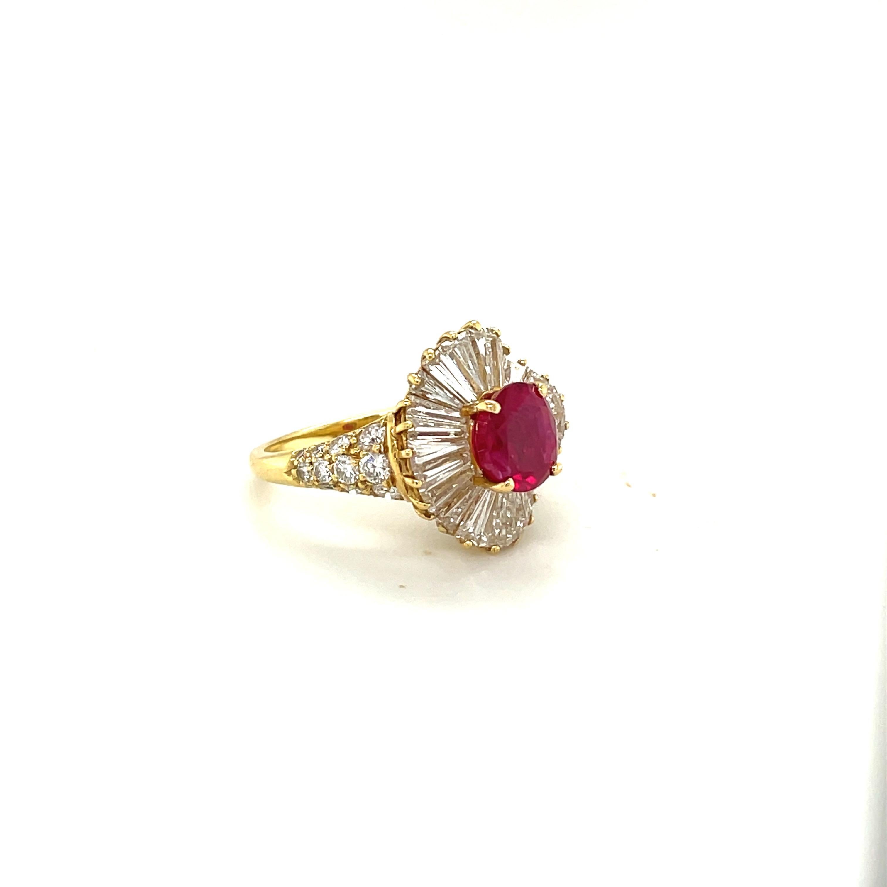 A classically designed 18 karat yellow gold ring set with a vibrant 2.89 carat oval Burmese ruby. The ruby sits in a ballerina setting of tapered baguette diamonds. Round brilliant diamonds are set half way down the shank.
Ruby weight 2.52
