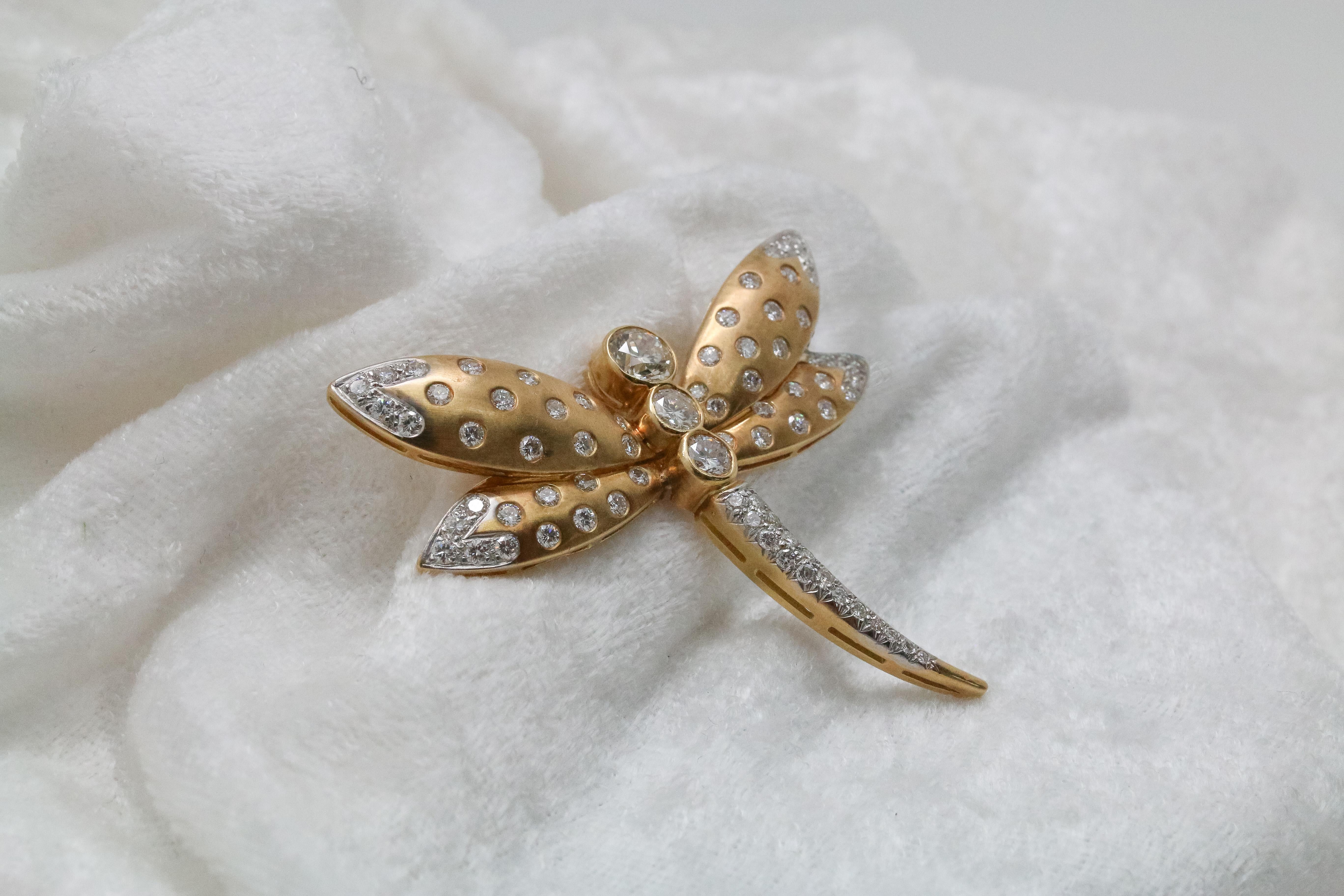 Showcasing this impressive and unique butterfly brooch that has been masterfully handcrafted and designed with 1.25 carats of Round Diamonds. A wonderful contrast of bezel set stones brings this lovely creature alive. Beautifully set in 18 karat