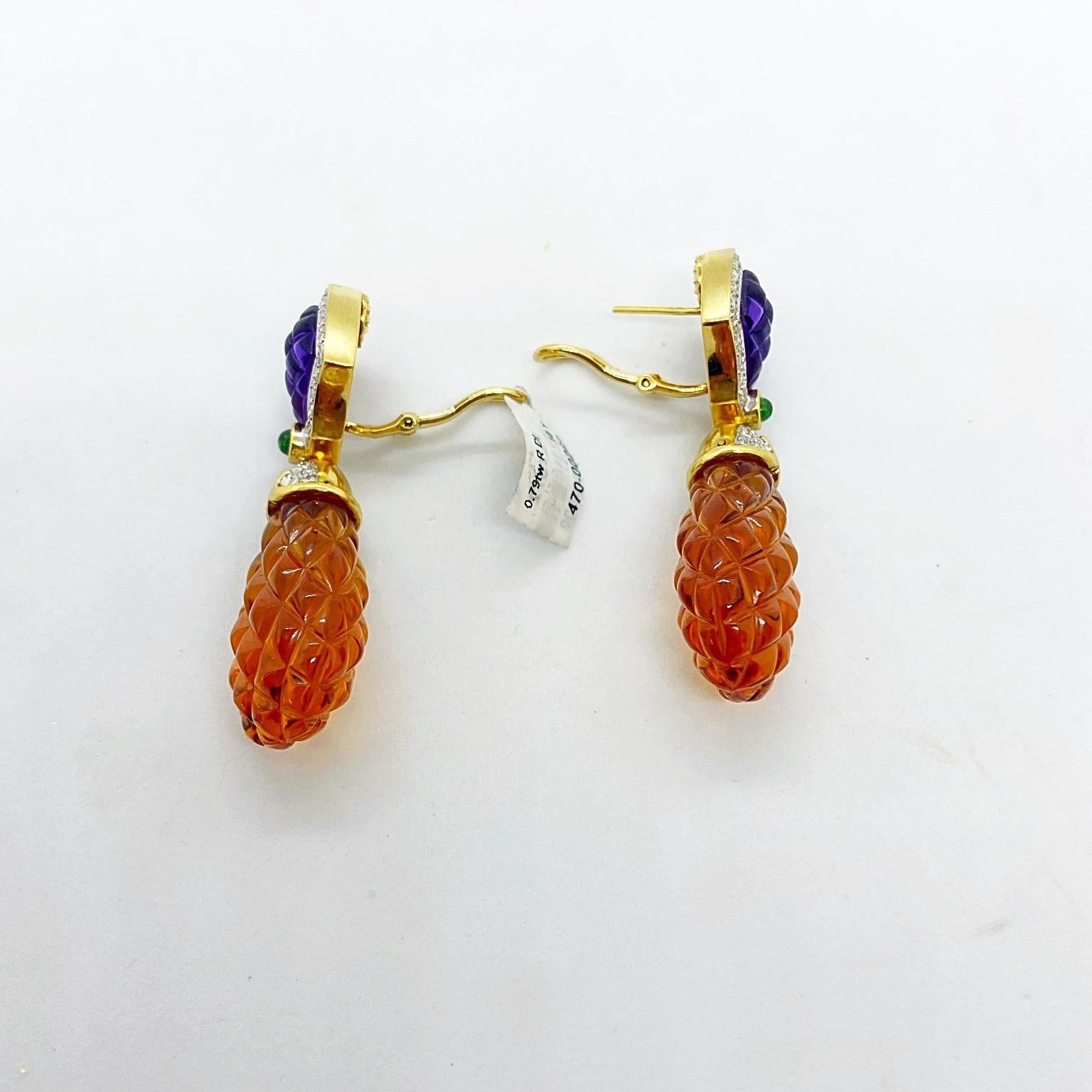 Beautiful Pineapple Earrings
These earrings are designed with a large carved teardrop shaped citrine stone., with a yellow gold and diamond cap. The top portion is carved amethyst outlined with a single row of diamonds. The two stones are joined