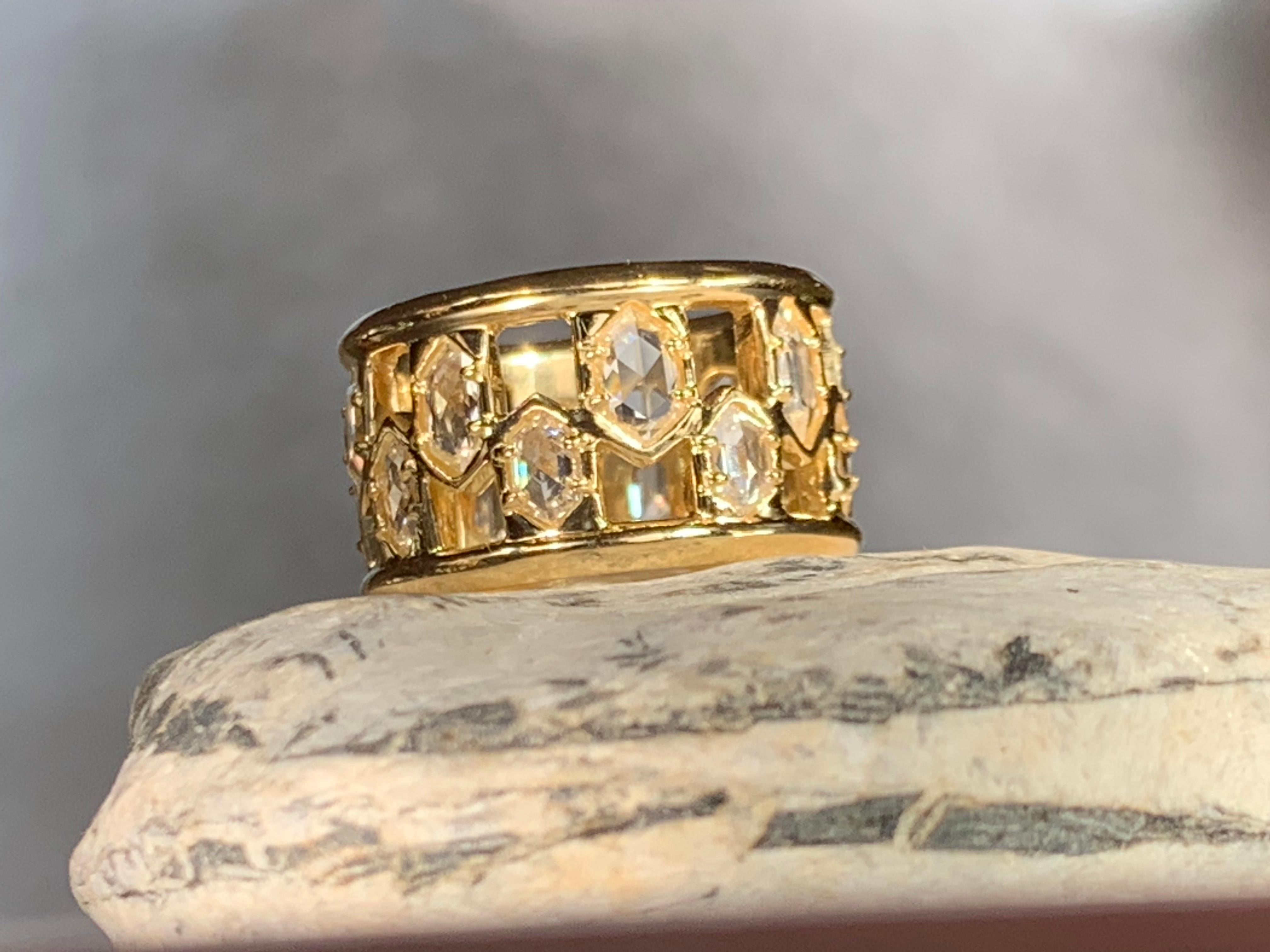 From a series of one-of-a-kind wide band rings, this 18kt yellow gold hexagonal diamond half inch wide band ring is patterned to create a spectacular light affect. We use fine quality white rose cut diamonds to heighten the sparkle.
This style of