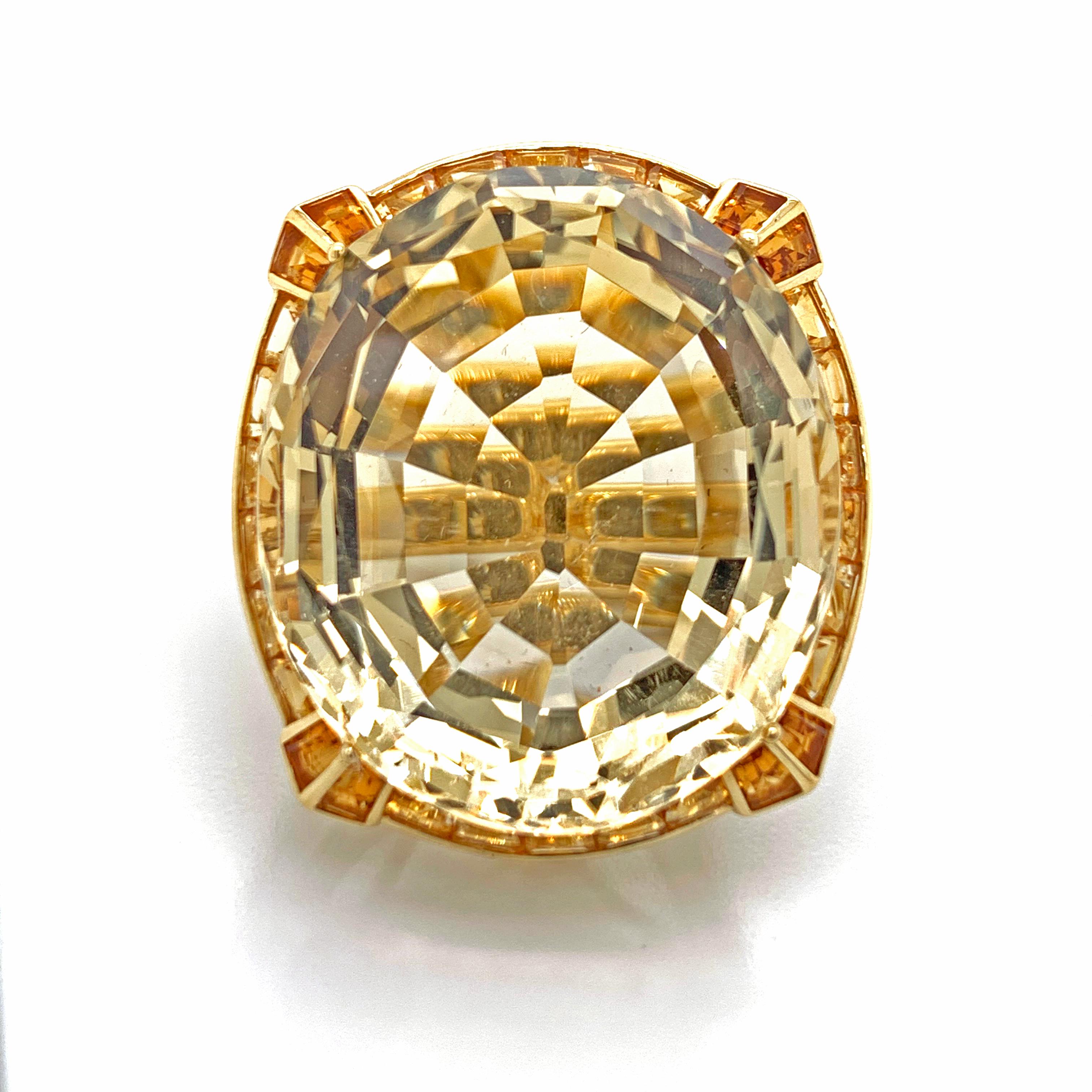 A, beautiful 18kt yellow gold ring. With, a beautiful Citrine center stone and with round small diamond going around the mounting of the ring. The ring also features Citrines on the side of the ring and complimenting the center stone. The, ring is