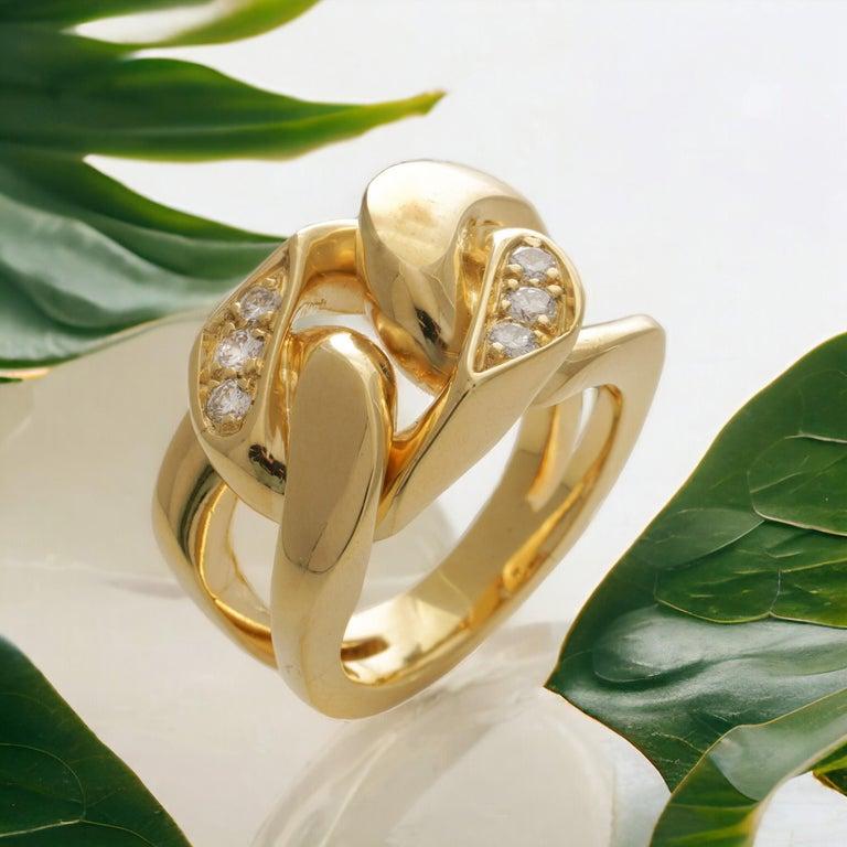 Modern 18kt. yellow gold curb link ladies band ring, set with round brilliant diamonds.  

Made in Europe, after 2000  
Hallmarked for 750 ( 18kt. gold standard )  

Dimensions - 
Finger Size (UK) = S (US) = 9.5 (EU) = 60
Weight: 30 grams
Size: 2.6
