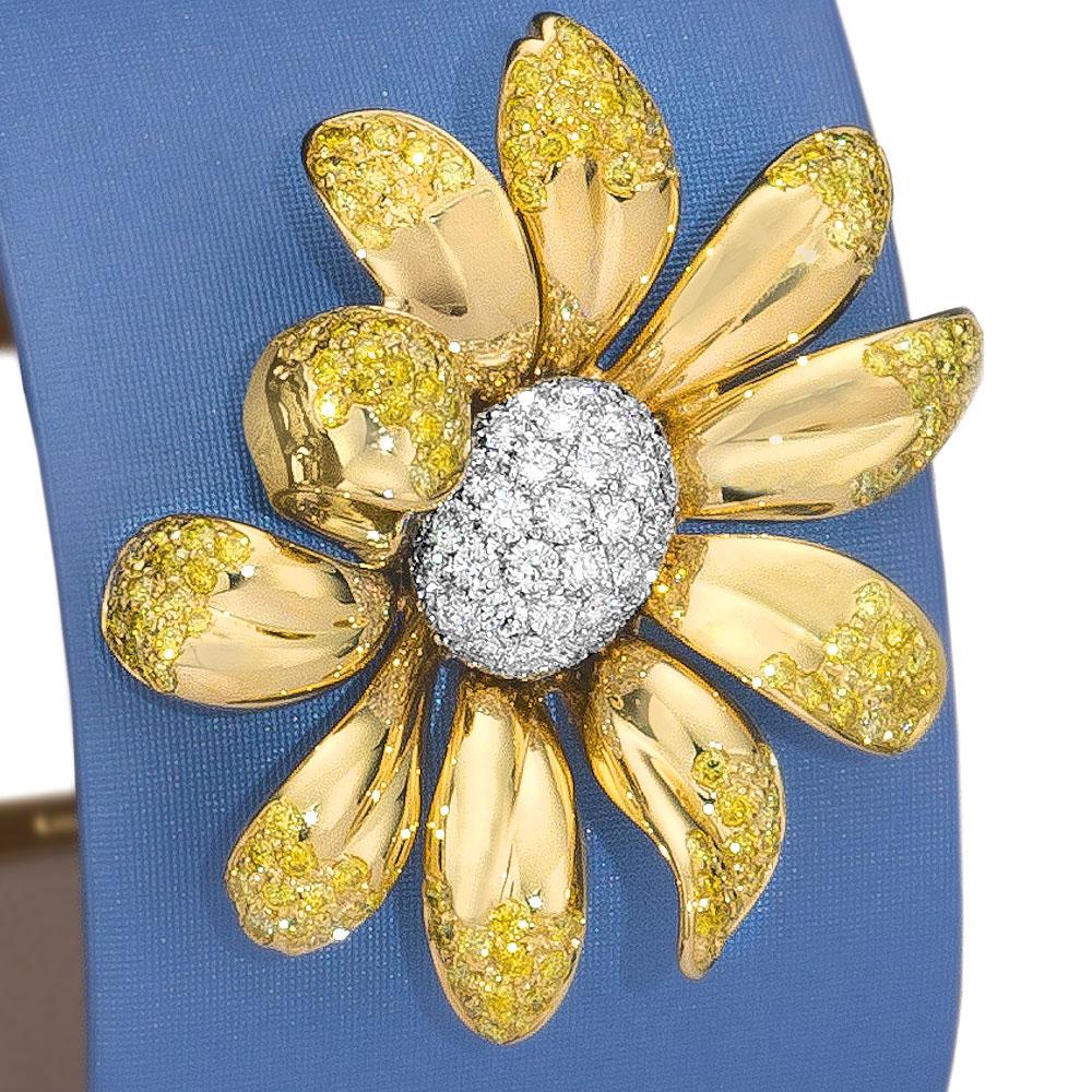 This elegant cuff bracelet is designed with an 18kt. yellow gold 3 dimensional Daisy . The daisy's 10 petals have been set at the tips with natural fancy yellow brilliant diamonds. The petals surround the center which has round white brilliant