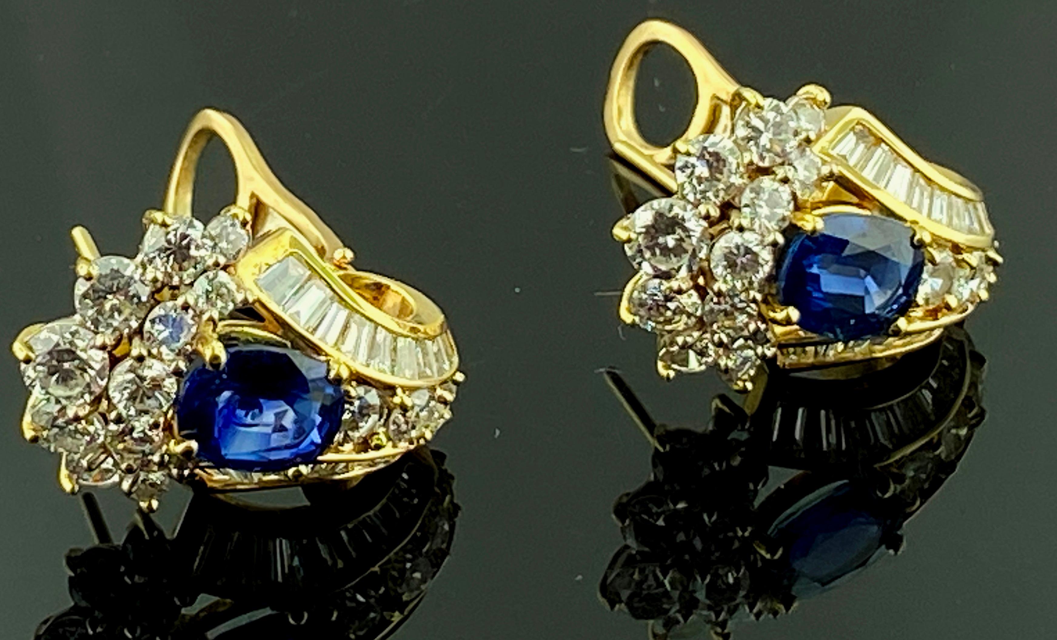 Set in 18 karat yellow gold are two Oval shaped Natural Blue Sapphires with a total weight of 2.58 carats.  Surrounding the Sapphires are 30 round brilliant cut diamonds and 36 baguette cut diamonds for a total diamond weight of 4.22 carats.
