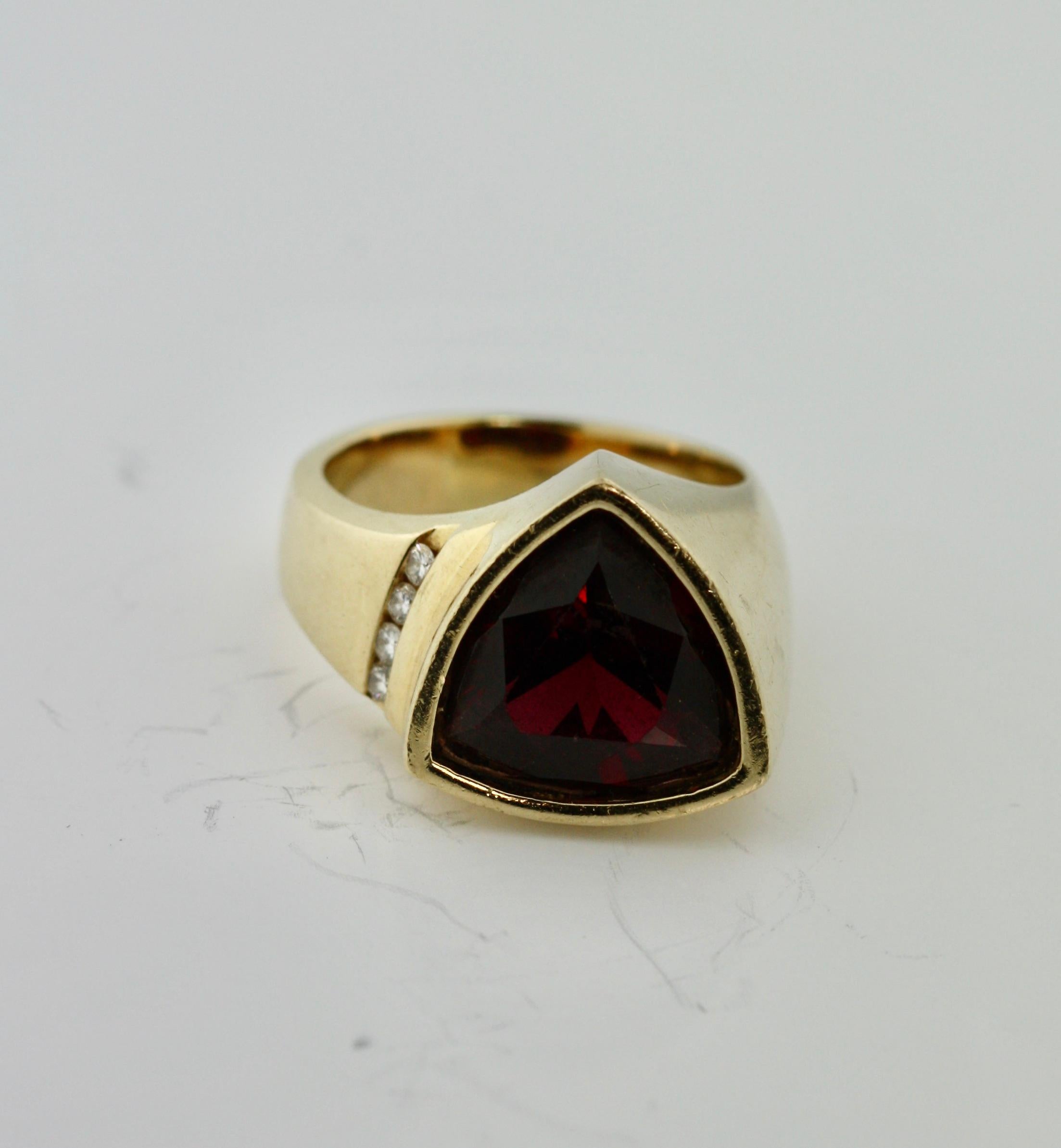 18kt Yellow Gold, Diamond and Garnet Ring
the modified triangular-shaped tsavorite garnet weighing approximately 12.00 carats, ring size 12