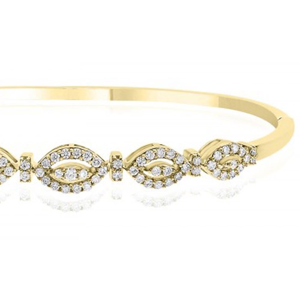 18kt yellow gold diamond bangle is sightly oval in shape to fit close to the wrist. Works great as an independent piece or can stack. (We also have in rose and white gold). There are 79 round brilliant diamonds and they total .73ct. 

The bangle is