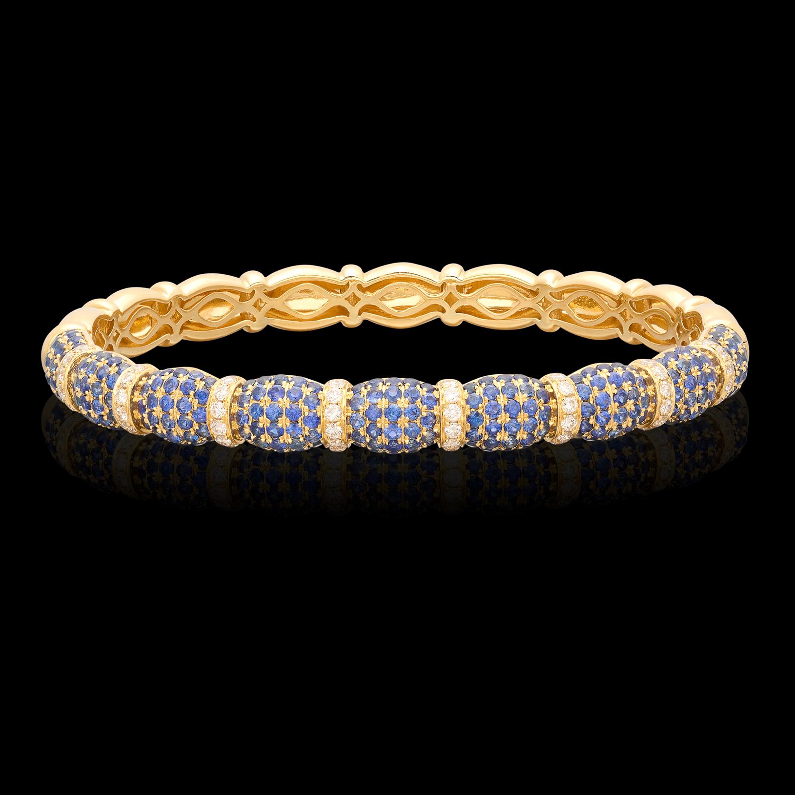 The perfect every day piece to help spruce up any outfit! This 18 karat yellow gold bangle features perfectly matched sections of fine sapphires and 0.48cttw diamonds that deliver sparkle for days. At almost half a carat, the diamonds average H