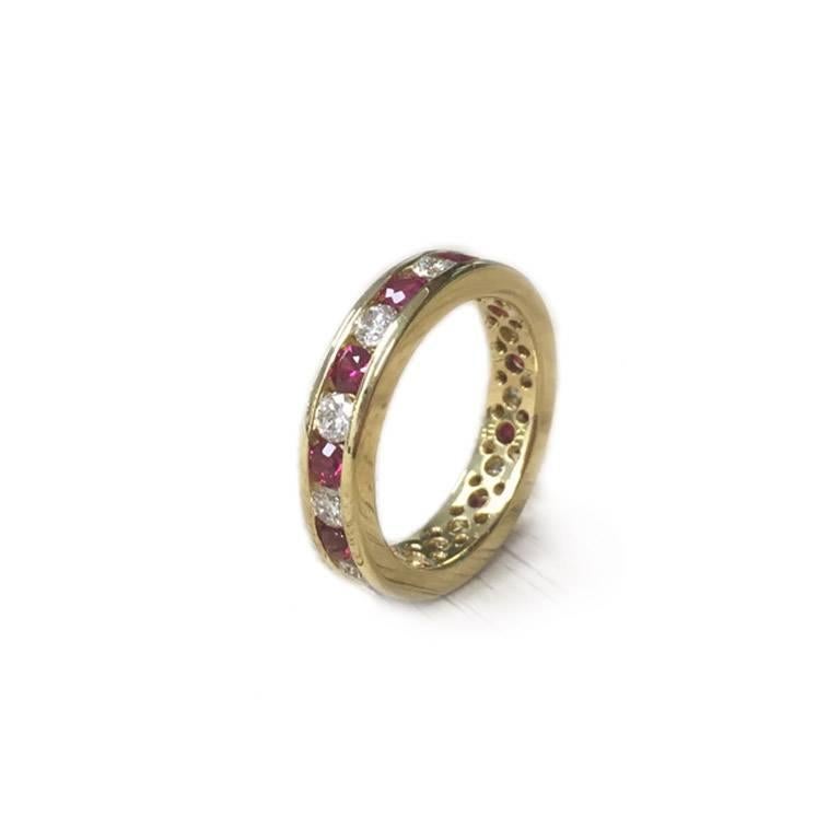 18Kt Yellow Gold Diamonds and Rubies Eternity Ring adorned with 11 round brilliant cut diamonds and 1 round rubies.

11 round brilliant cut diamonds weighing 0.77ct total, clarity VS, color F-G
11 round rubies weighing 1.10ct total

Finger size: