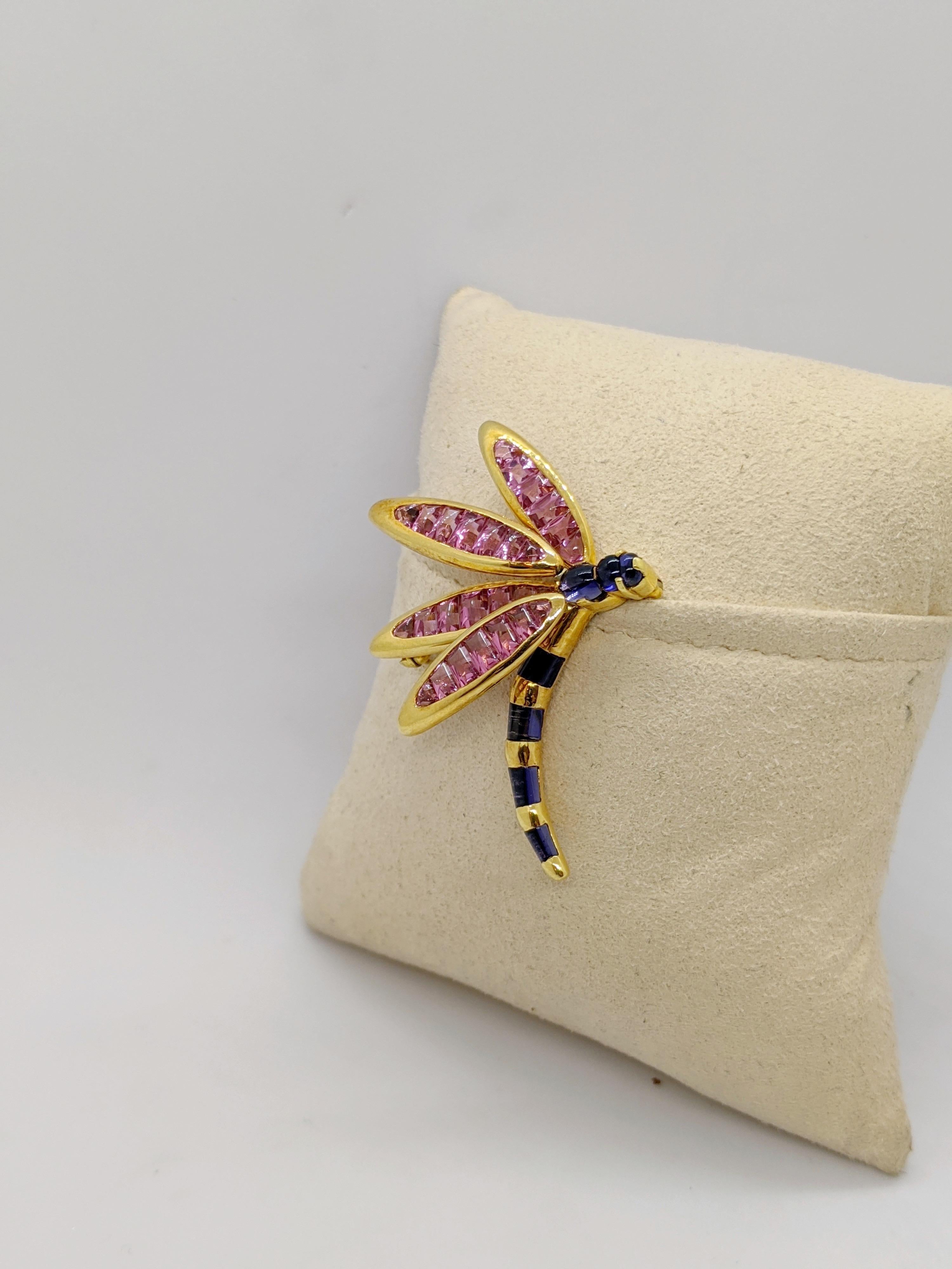 18 karat yellow gold Dragonfly brooch is set with Pink Tourmaline Baguette stones in the four wings and Iolite stones as the body. Two of the wings are able to flutter. The brooch measures approximately 2