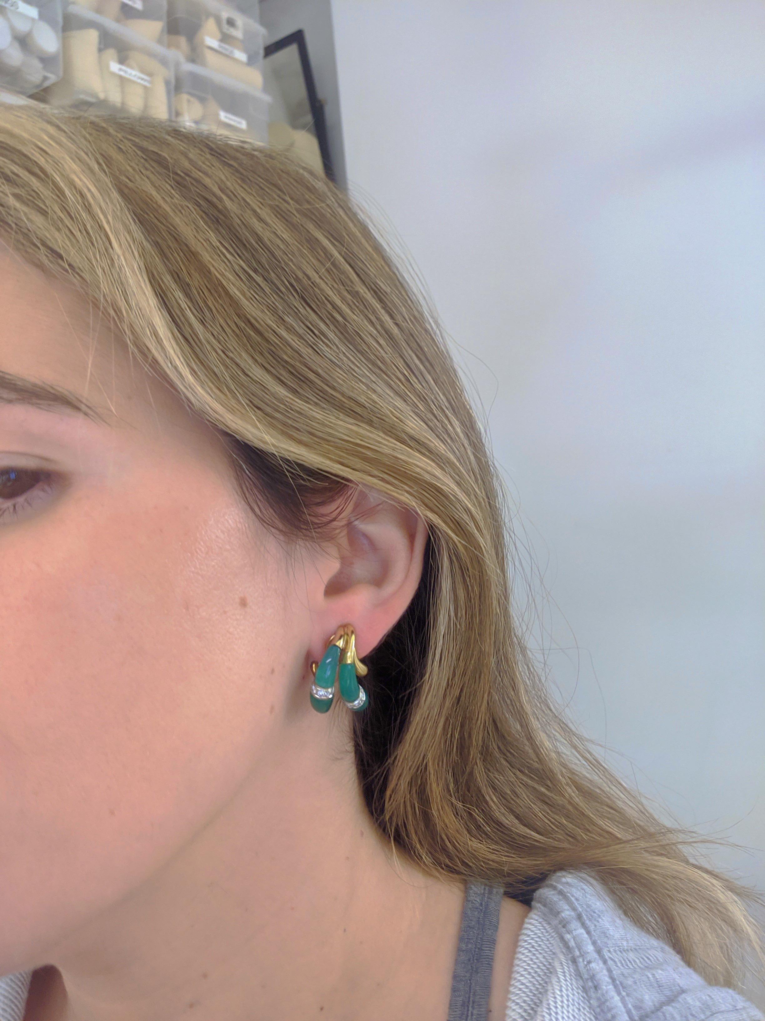 18 karat yellow gold earrings designed with two drop sections of carved Chrysoprase accented with round brilliant Diamonds. These earrings are clip on , but a post can be added. They measure 1
