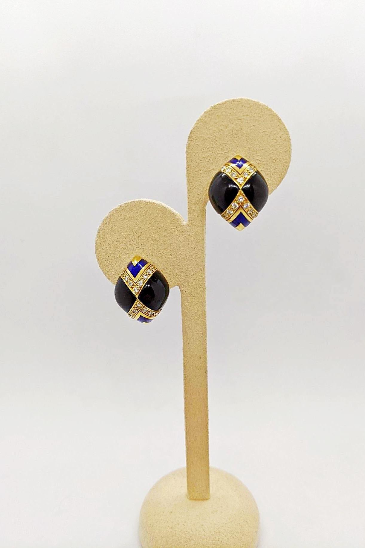 One pair of 18 karat yellow gold earrings set with a combination of Black Onyx, Blue Enamel and Diamonds. The earrings have a post back and a clip, but can be adjusted for non pierced ears. The oval shaped earring measures 3/4