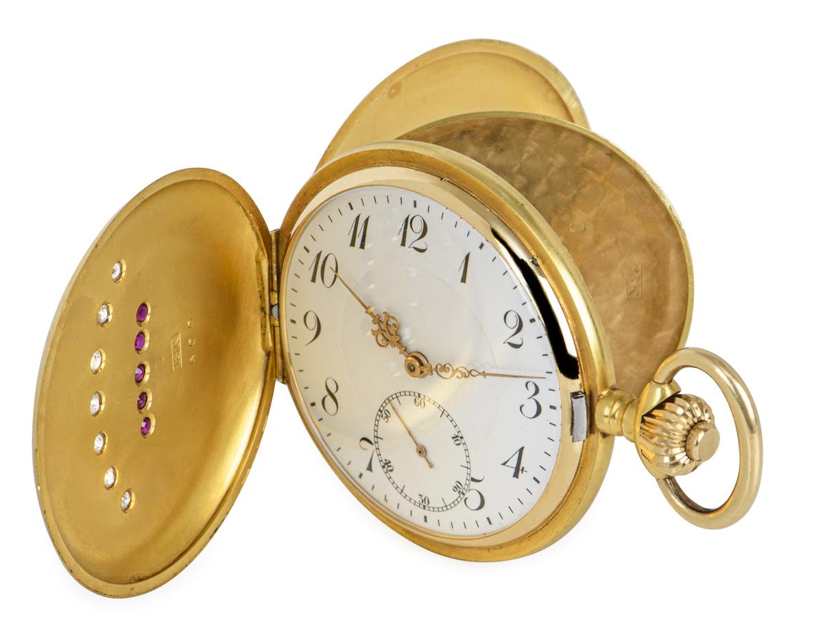 18kt Yellow Gold Full Hunter, 50mm Keyless Wind Lever Pocket Watch with Crown Motif set with Diamonds and Rubies C1890's

Dial: A beautiful white enamel dial with Arabic numeral and outer minute track, subsidiary seconds dial and intricate gold hour