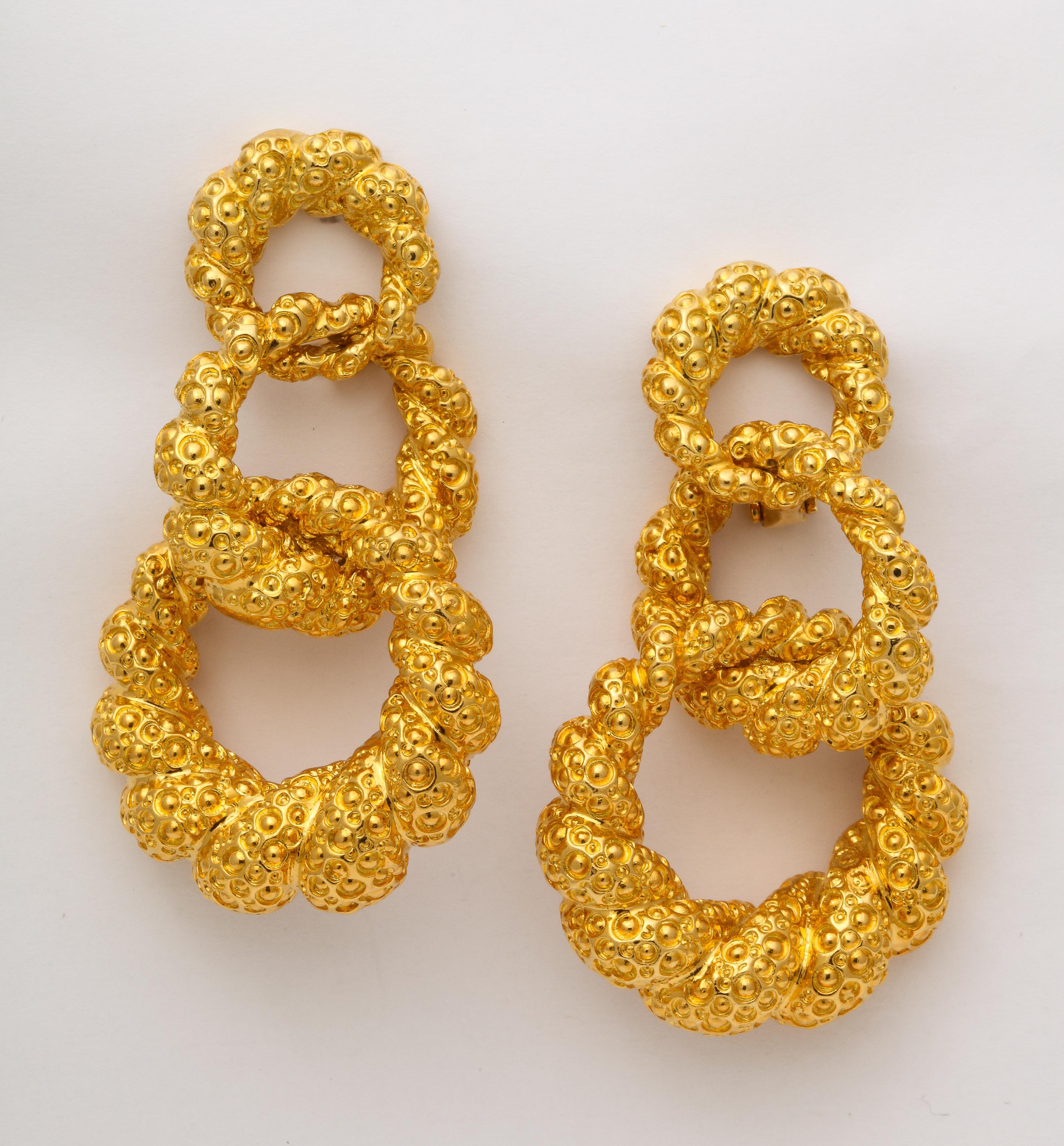 Ca 1980 = Large Triple Hoop clip on 18kt Yellow Gold Earrings.  Facing left and facing right.  Earring Backs are 14kt Clips.
Very cha-cha-cha -  Certainly right for any mood - from frivolous to super chic.